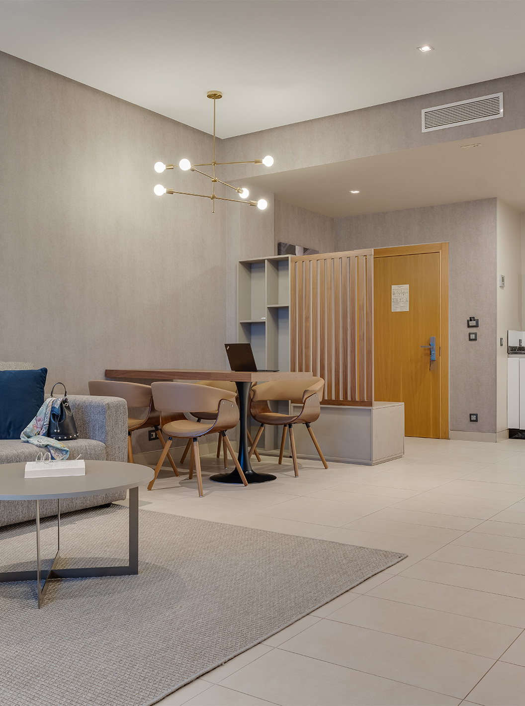 The Family Premium Superior Suite at Pestana Casablanca has a spacious living room with a sofa, TV, and kitchenette