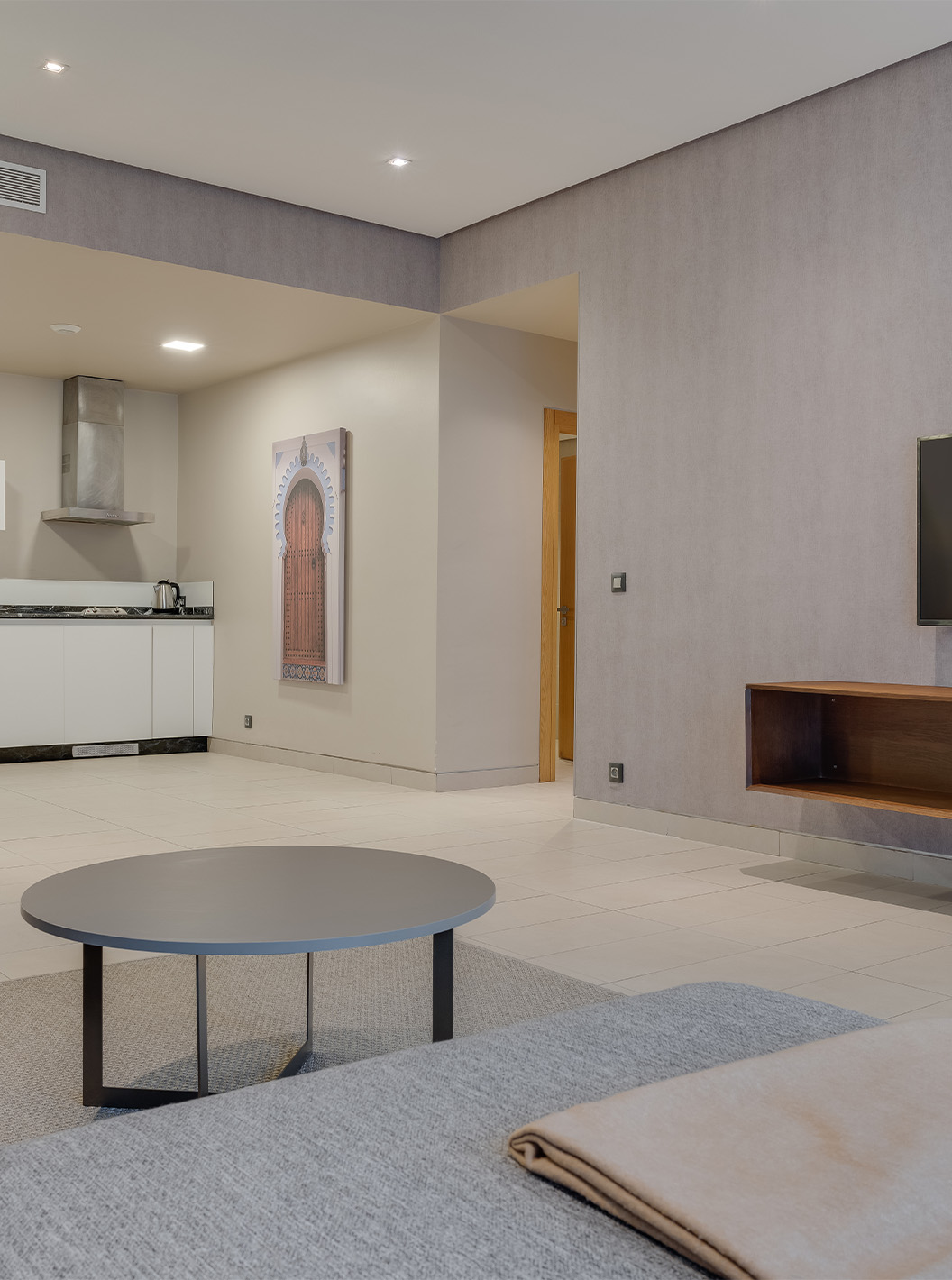 The Family Premium Suite at Pestana Casablanca has a comfortable sofa with chaise longue, a TV, and a kitchenette