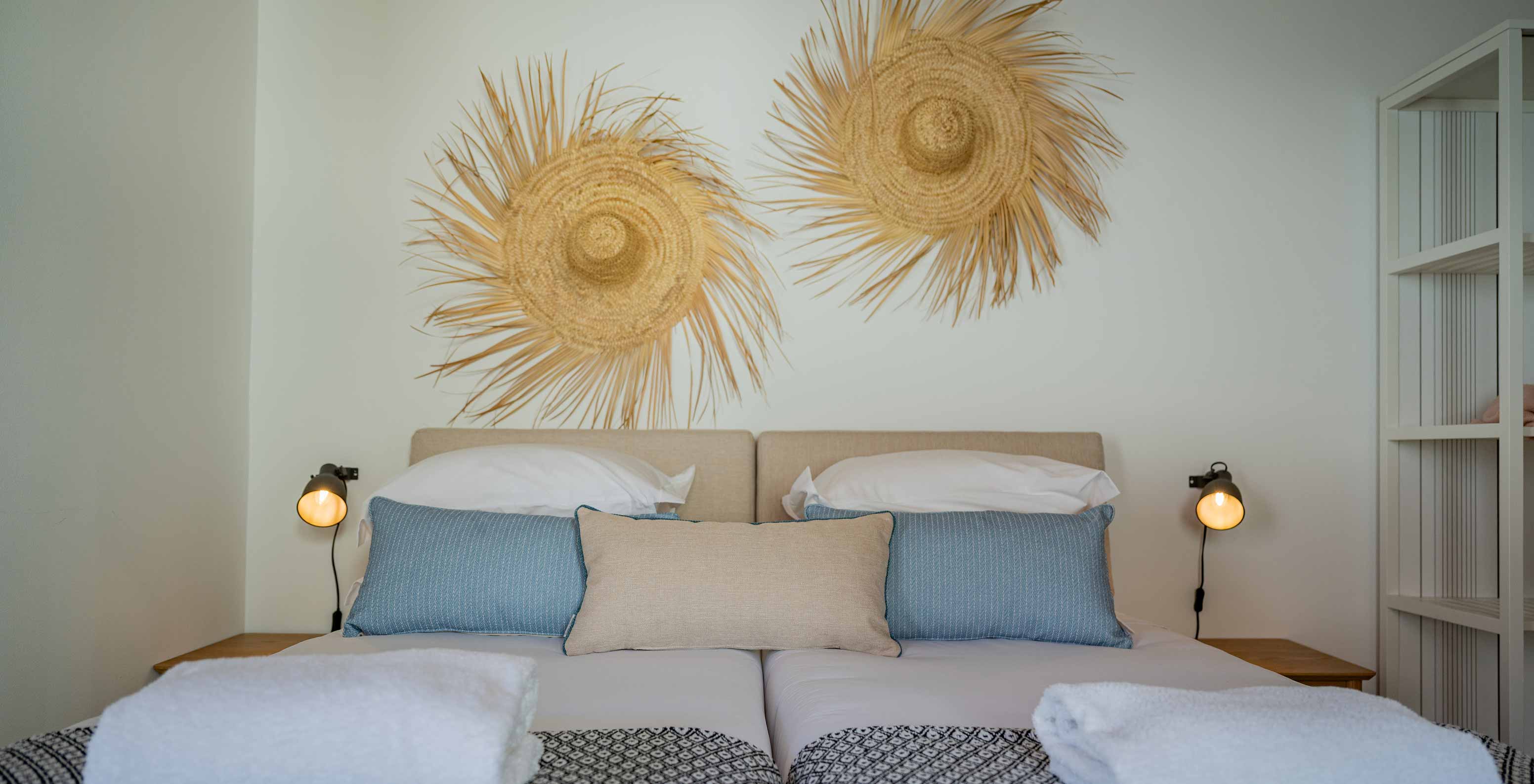 The Superior Green Villa at Pestana Comporta Village Residences has a double bed with straw decoration on the wall