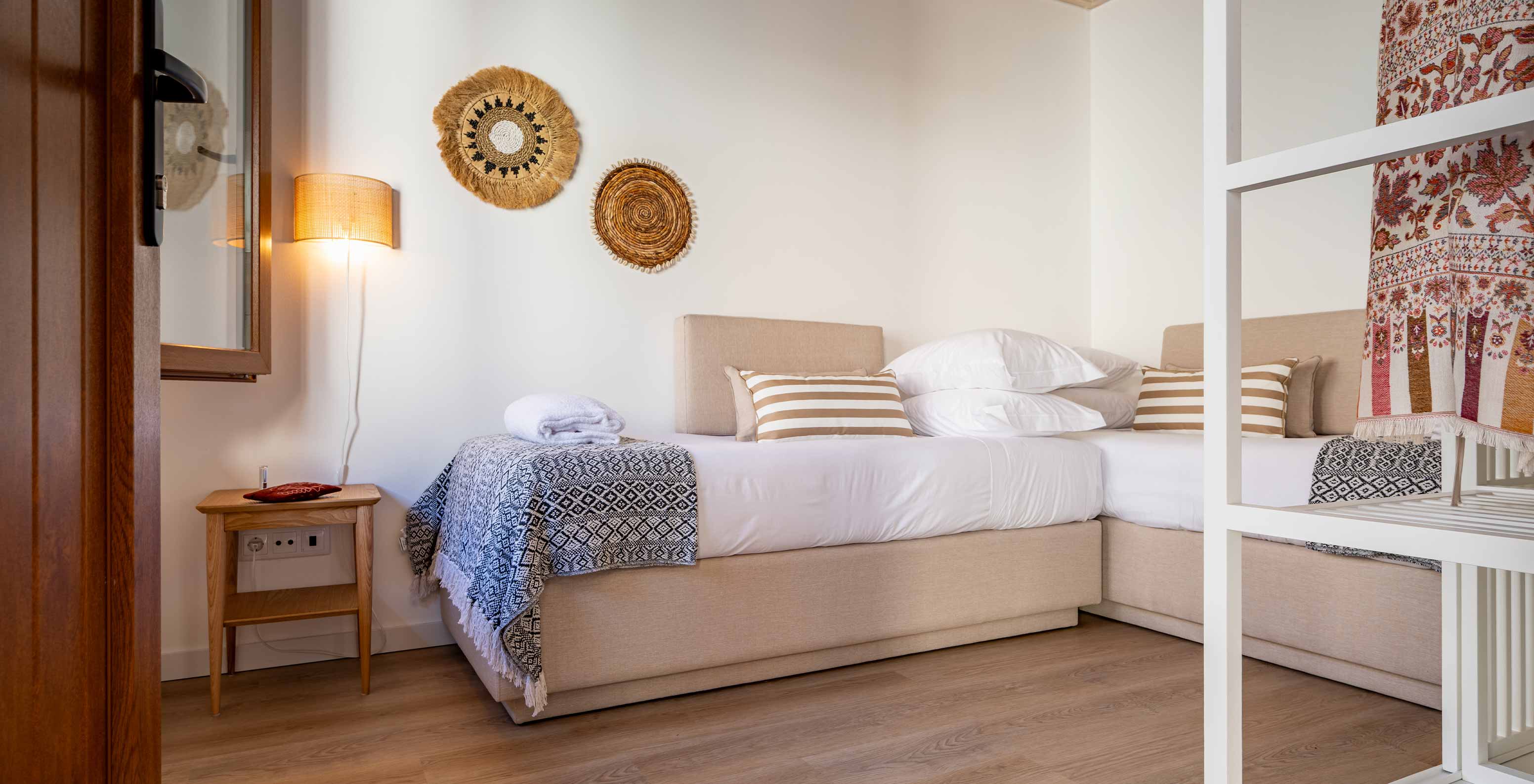 The Superior Villa at Pestana Comporta Village Residences has a small bedroom with a sofa and minimalist decor