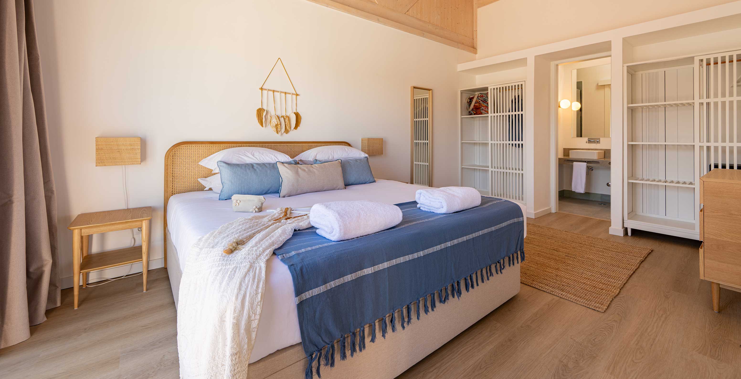 The Premium Villa at Pestana Comporta Village Residences has a bedroom with a double bed and several blue pillows