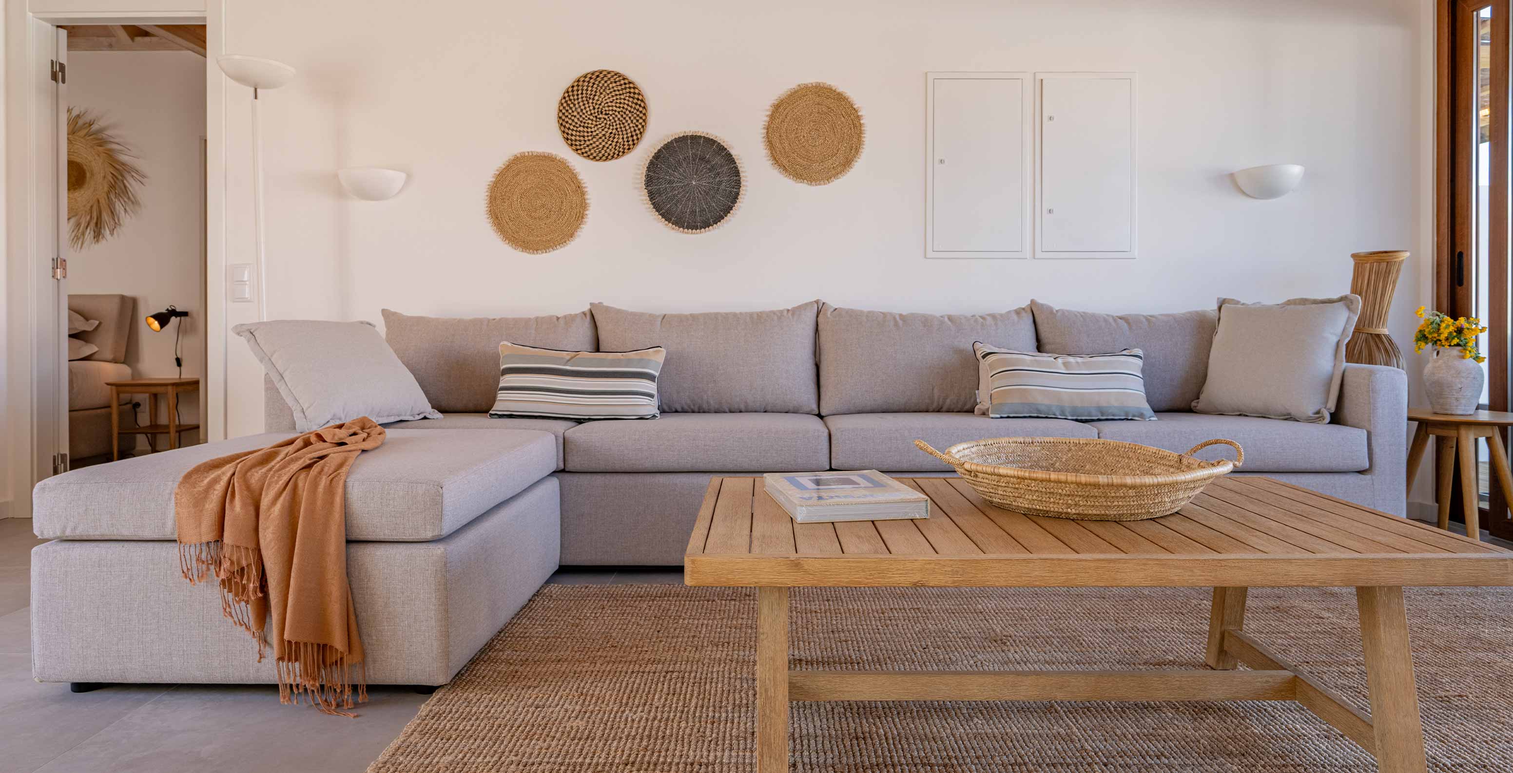 The Superior Villa at Pestana Comporta Village Residences has a living room with a gray sofa and a table