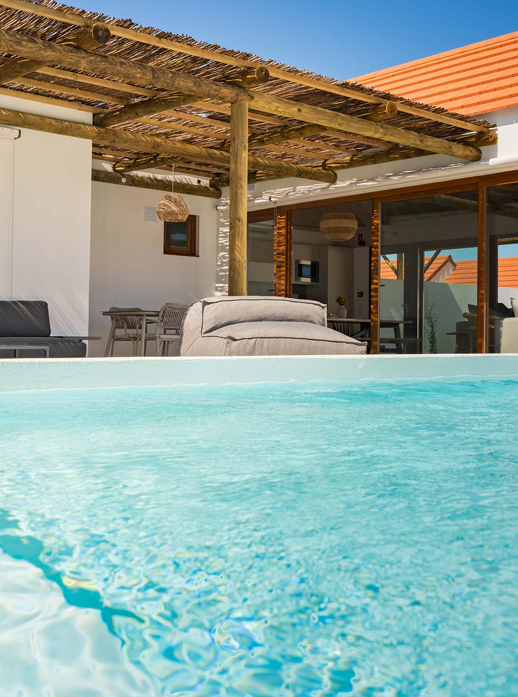 The Premium Green Villa at Pestana Comporta Village Residences has an outdoor pool area with sofas and a table