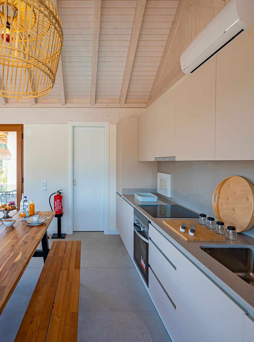 The Standard Green Villa at Pestana Comporta Village Residences has a modern kitchen with a wooden table and an oven