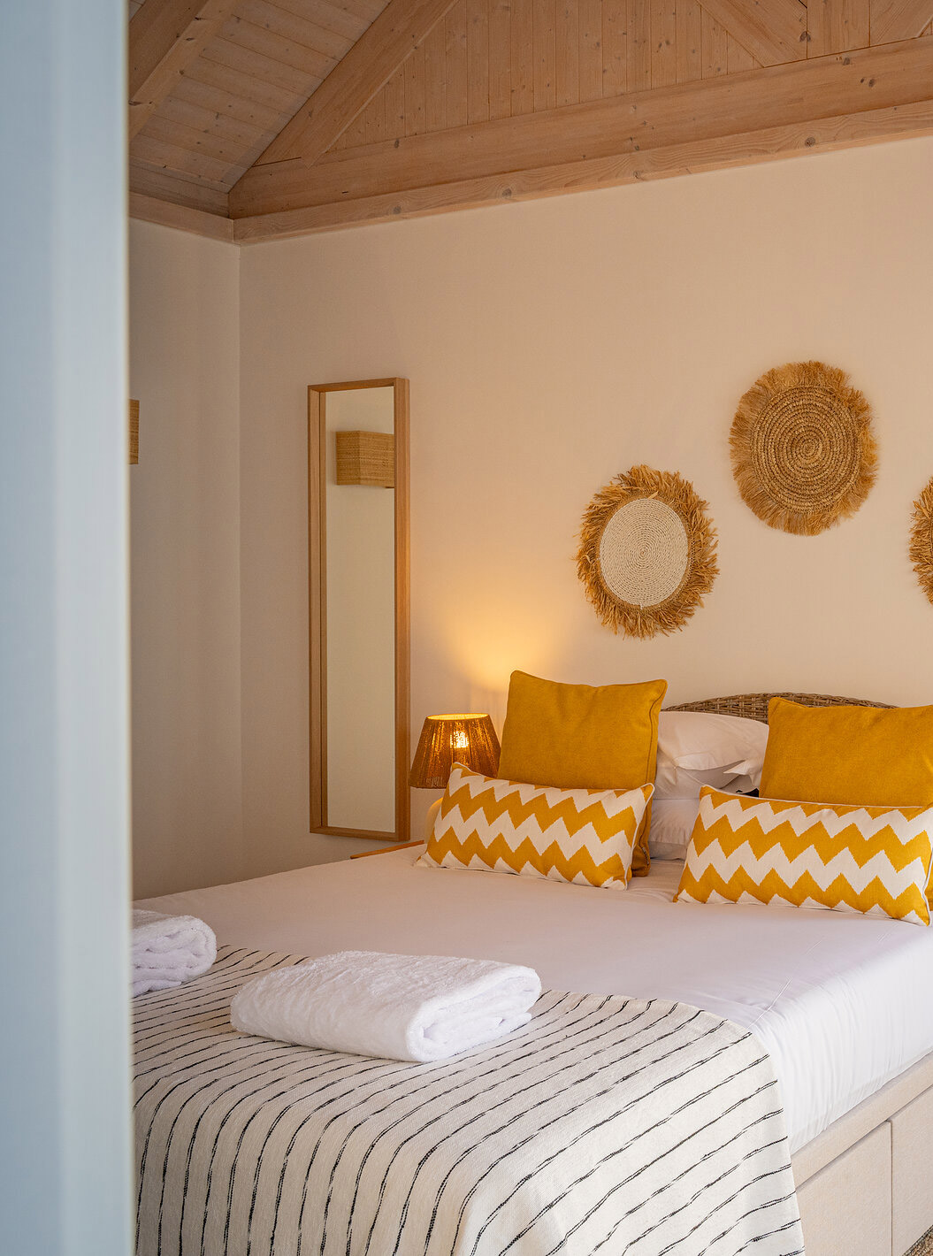 The Superior Green Villa at Pestana Comporta Village Residences has a bedroom with a double bed and yellow pillows