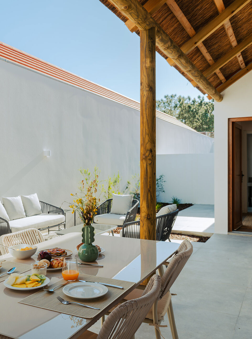 The Superior Villa at Pestana Comporta Village Residences has an outdoor patio with a dining table and a sofa