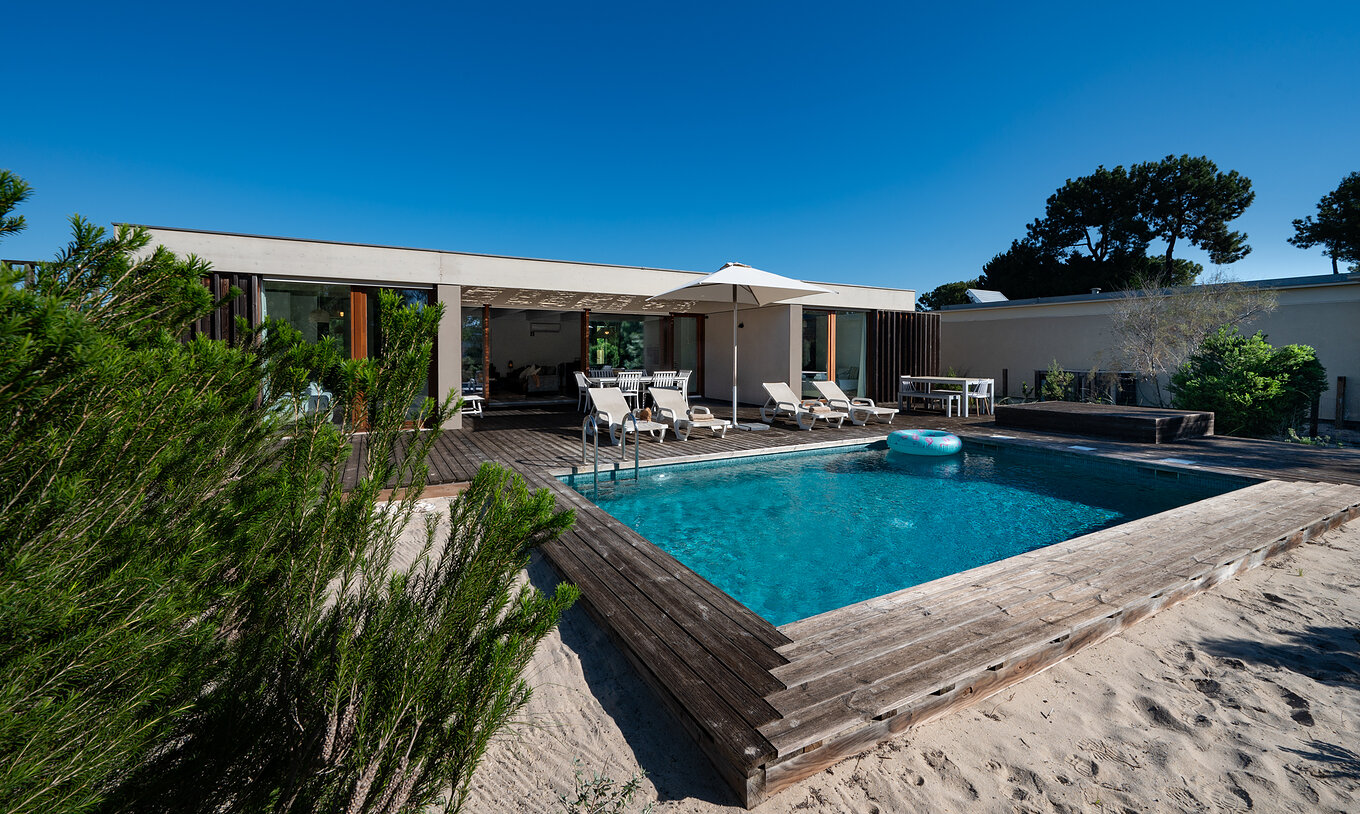 The Beach Villa with Private Pool of Pestana Tróia Eco Resort has several sun loungers, a sun umbrella, and a float
