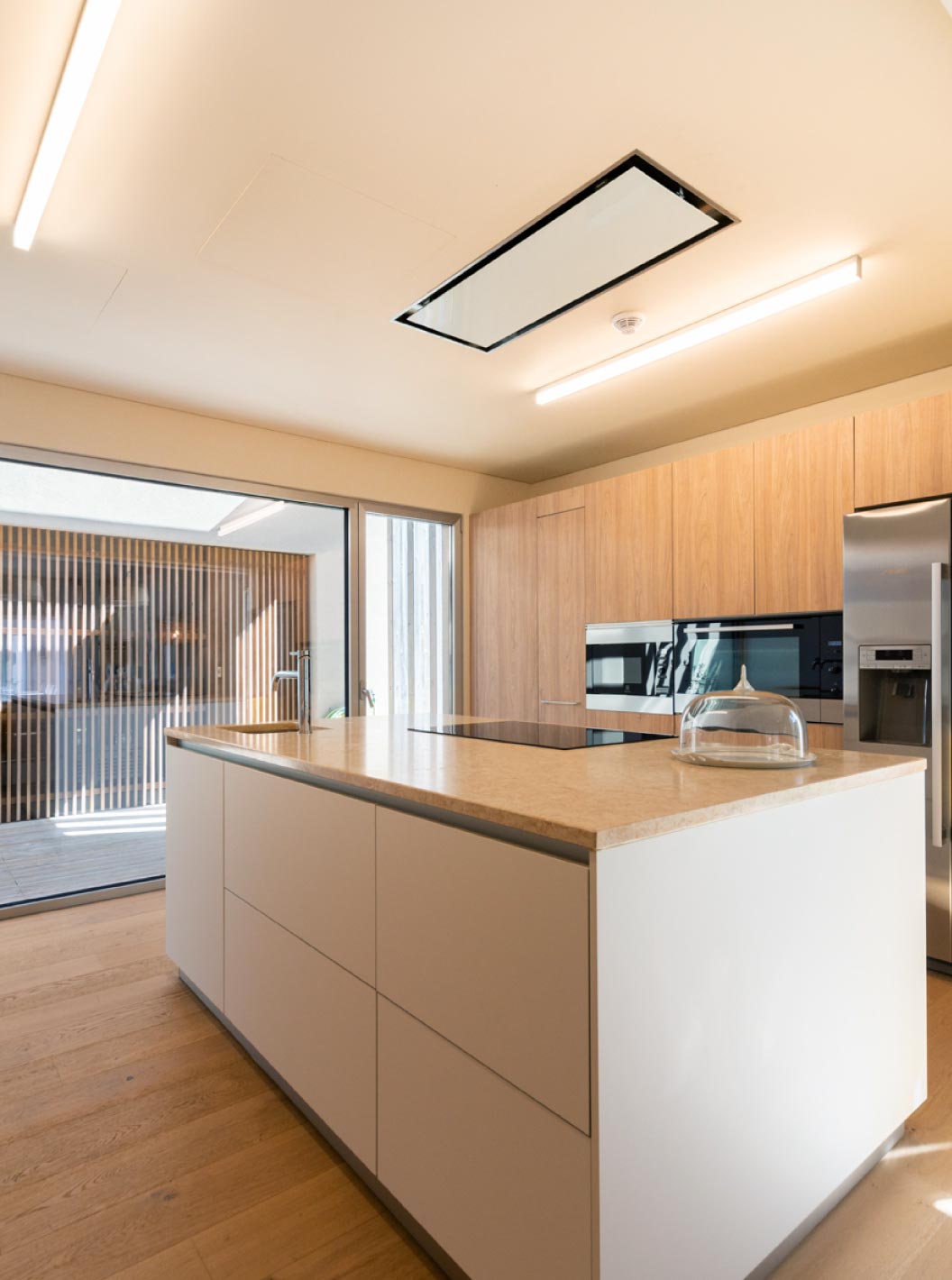 The exclusive villa with a pool at Pestana Tróia Eco Resort has a kitchen with wooden cabinets and a central island