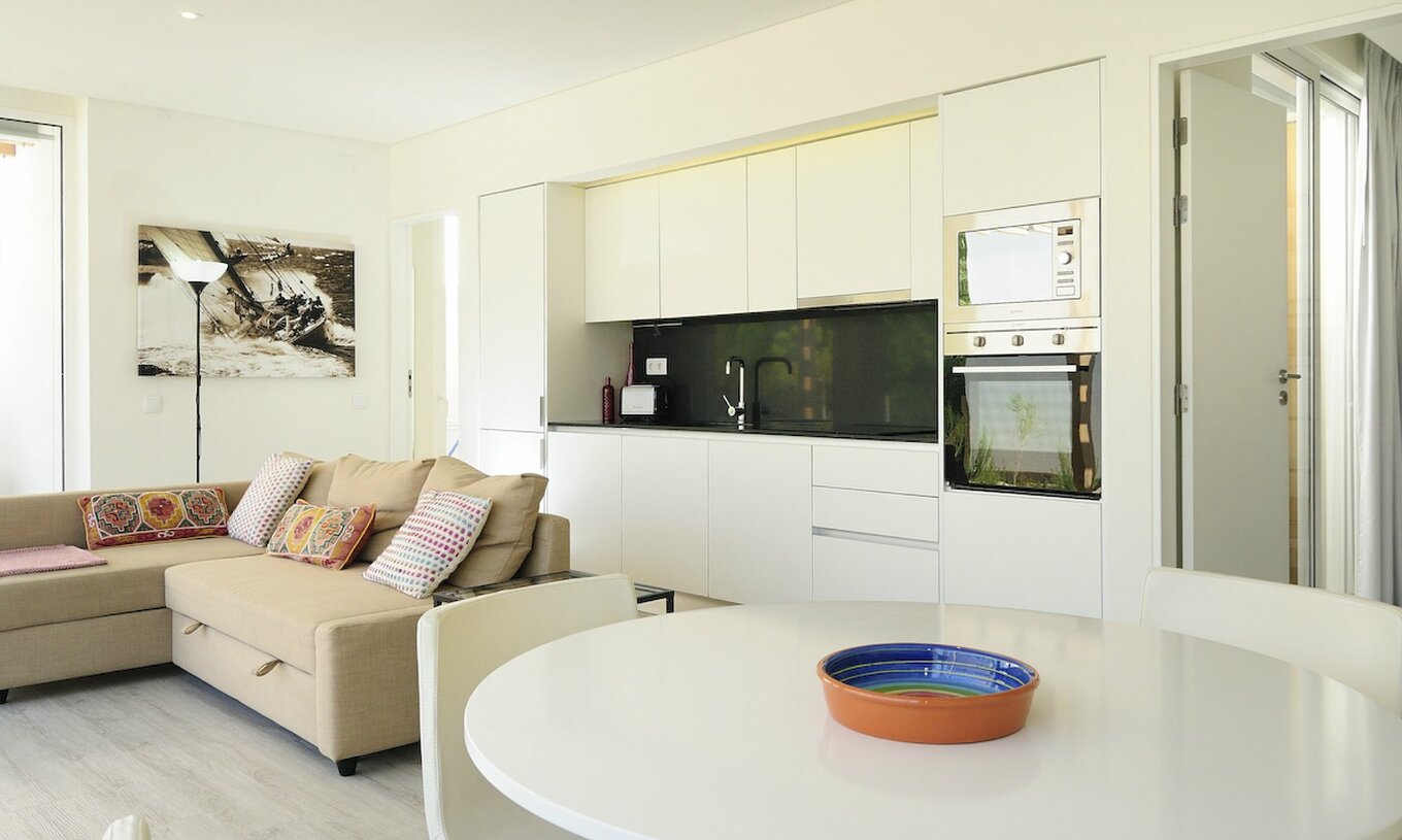 The Green T3 Villa with Private Pool of Pestana Tróia Eco Resort has a room combined with the kitchen, sofa, and dining table