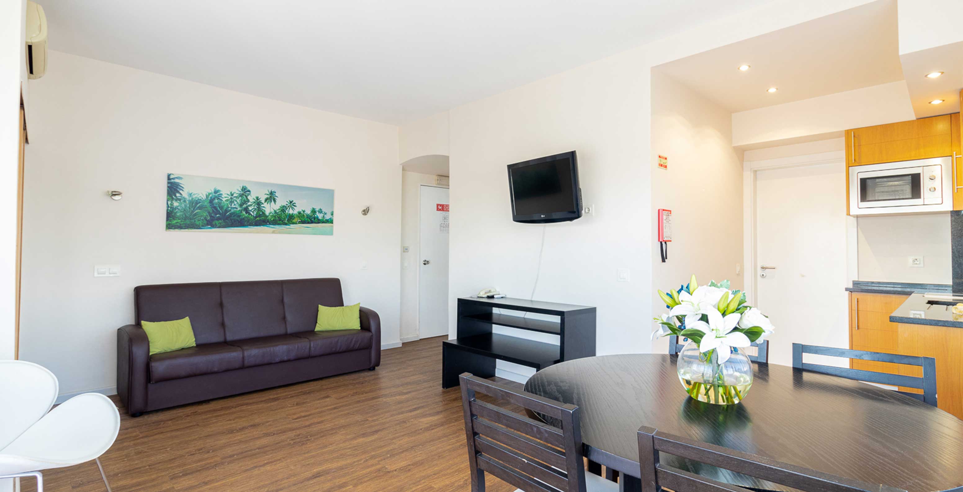 In the T1 Garden View Apartment at Pestana Alvor Atlântico, you can enjoy the living room with table, sofa, and TV