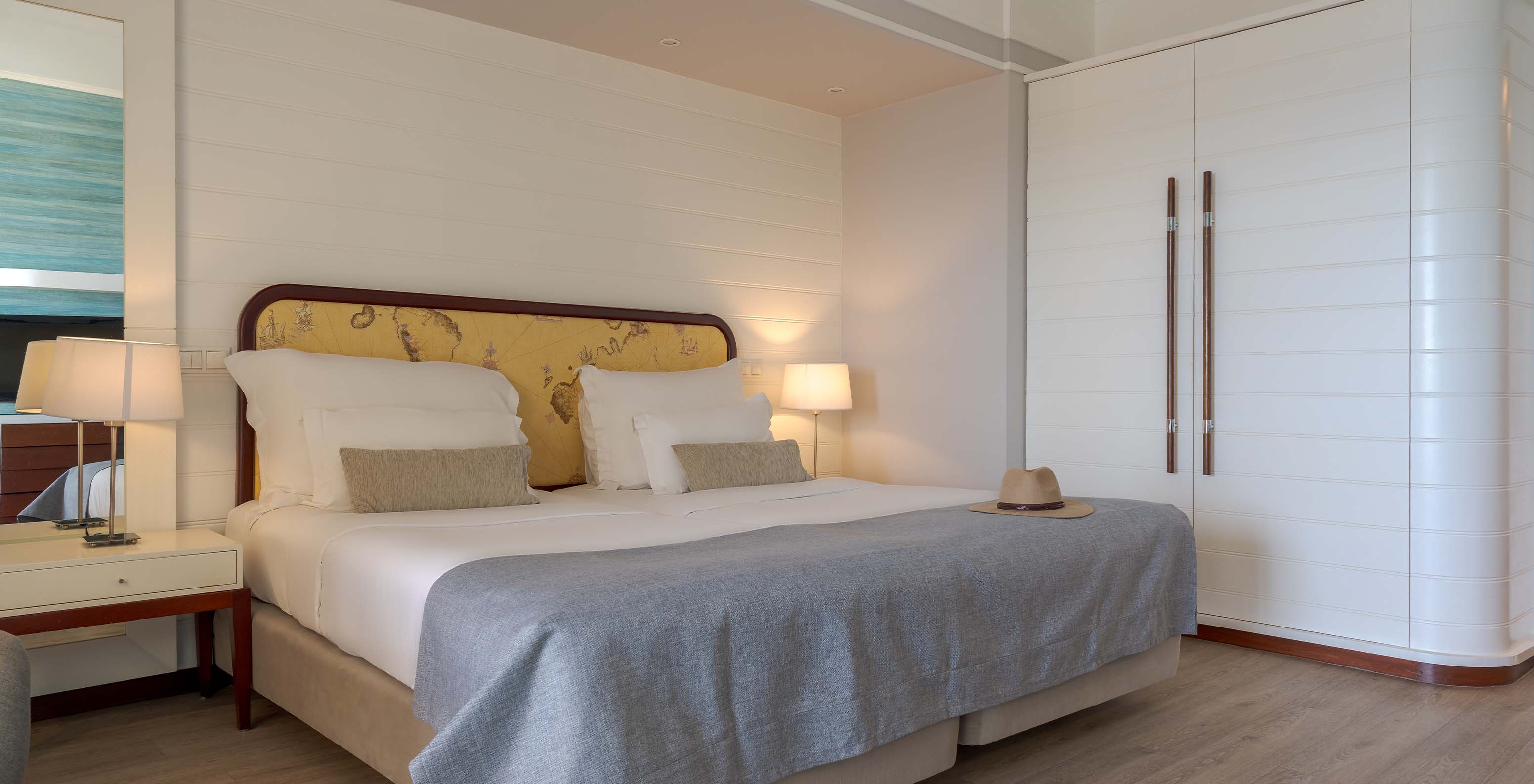 The Superior Sea View at Pestana Alvor Praia has two joined beds with bedside tables and a white wardrobe