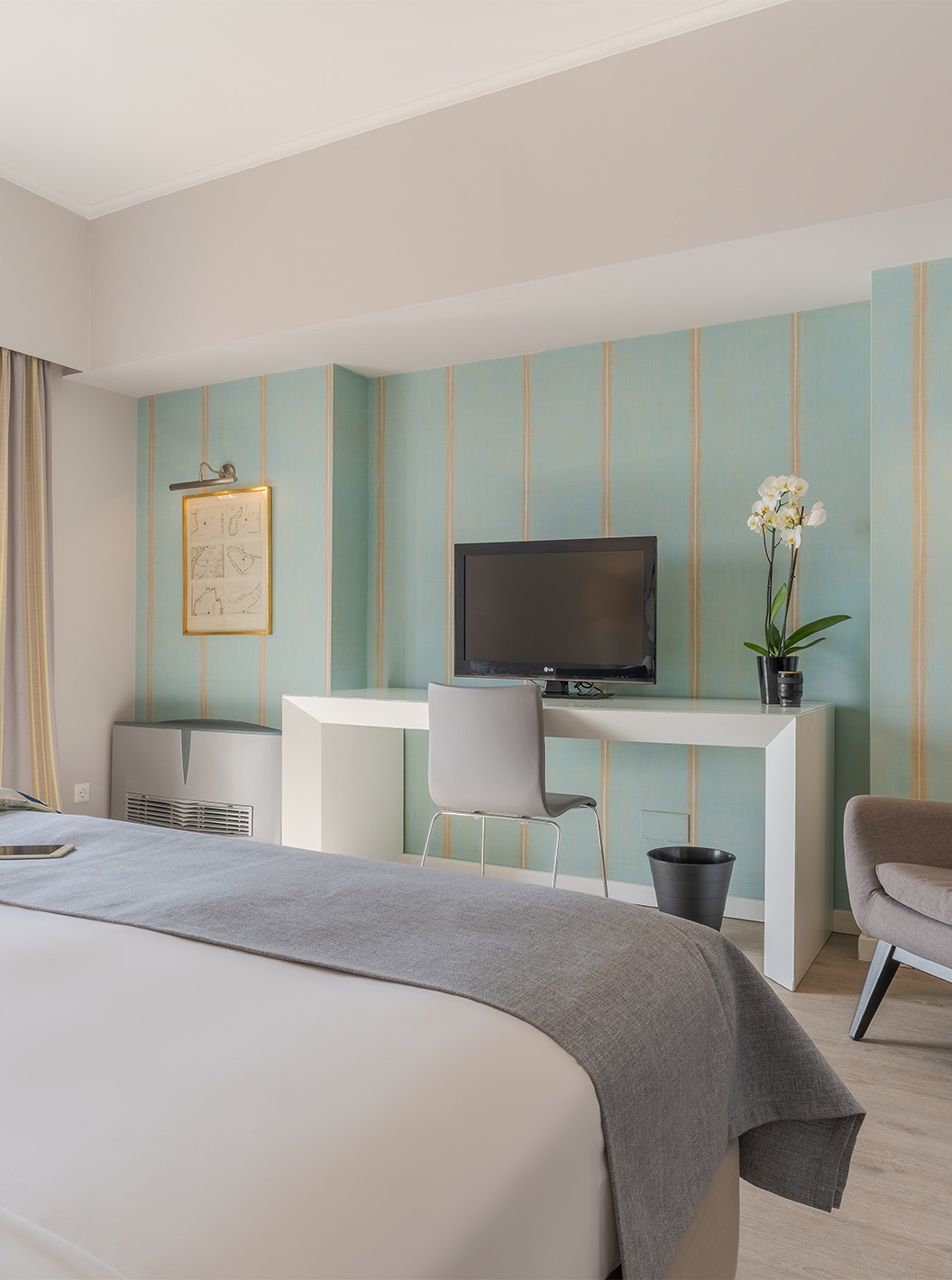 The Luxury Sea View Suite at Pestana Alvor Praia has a double bed, an armchair, a desk with TV, and sea views