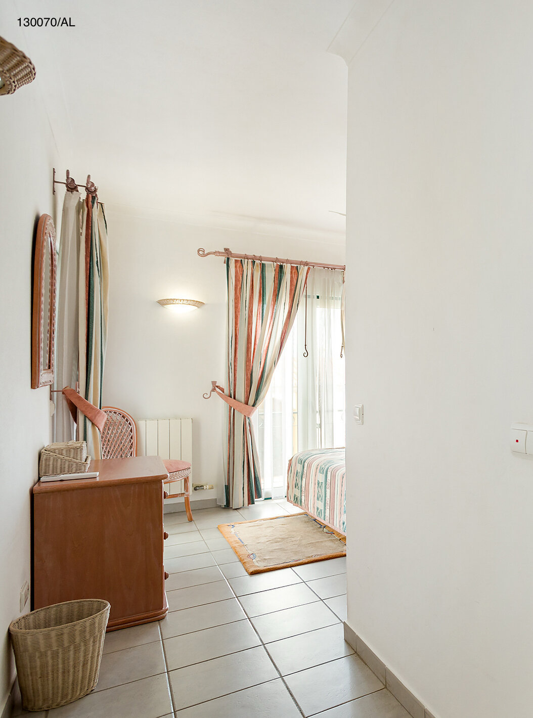 The Pestana Carvoeiro Golf T2 Superior Apartment has a bedroom with a bathroom and a wooden drawer unit