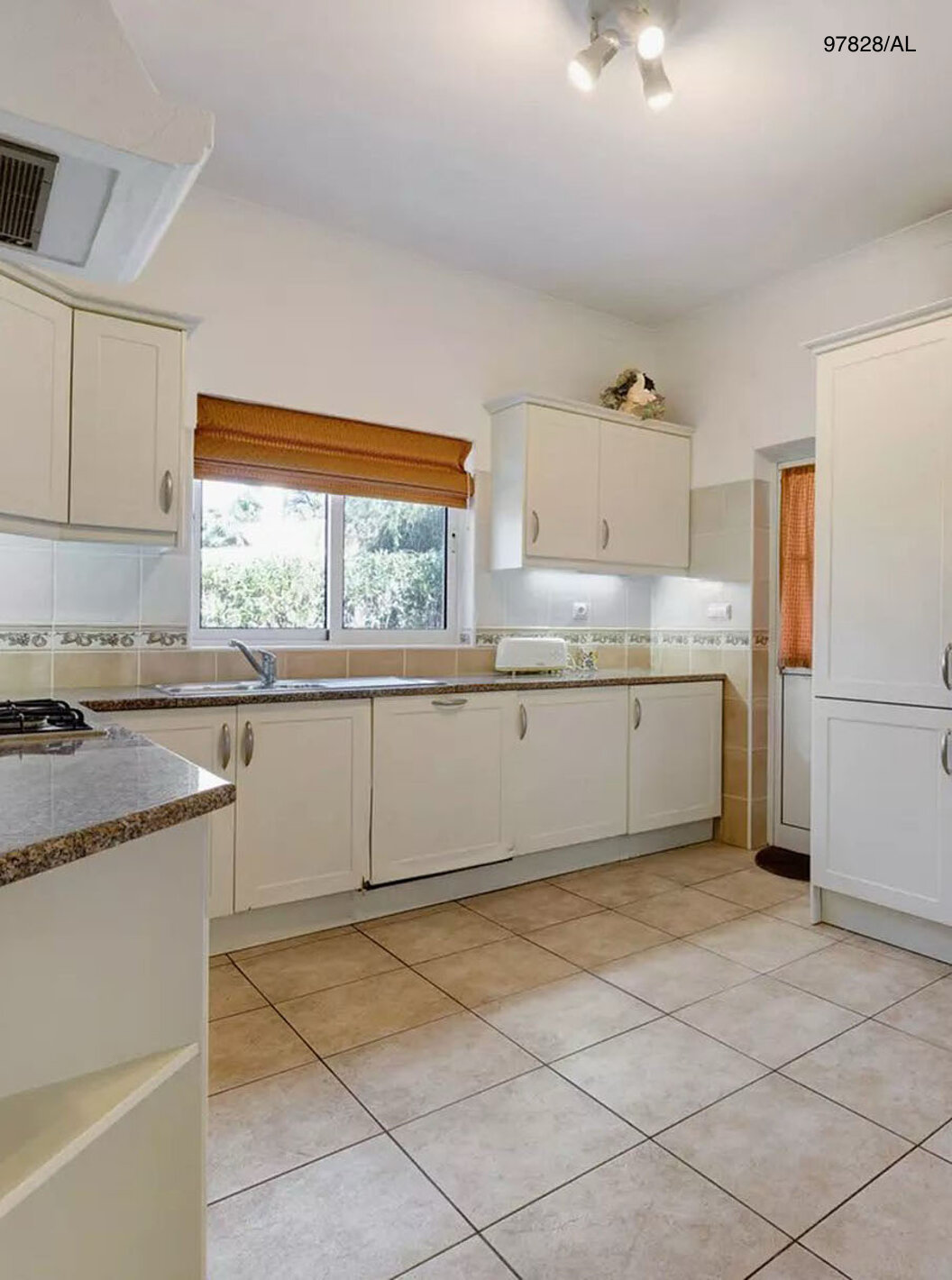 The Pestana Carvoeiro Golf V3 Standard Villa has a kitchen equipped with white cabinets and appliances