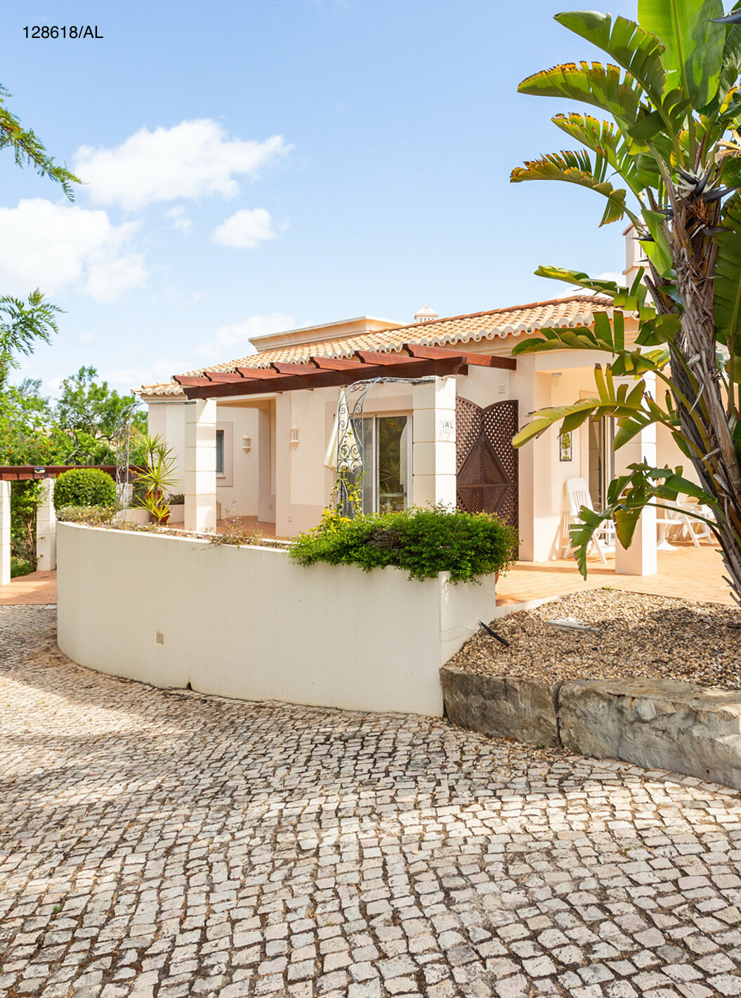 The Pestana Carvoeiro Golf V3 Superior Villa has an exterior patio with grass and trees around it