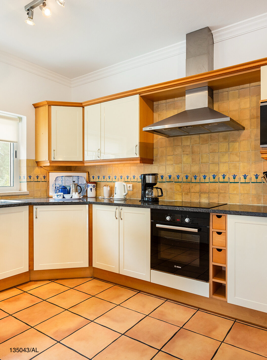 The Pestana Carvoeiro Golf V4 Standard Villa has a kitchen equipped with white cabinets and appliances