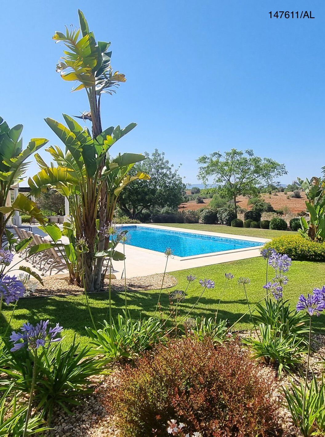 The Pestana Carvoeiro Golf V5 Superior Villa has an exterior patio with a pool, grass, and trees around it