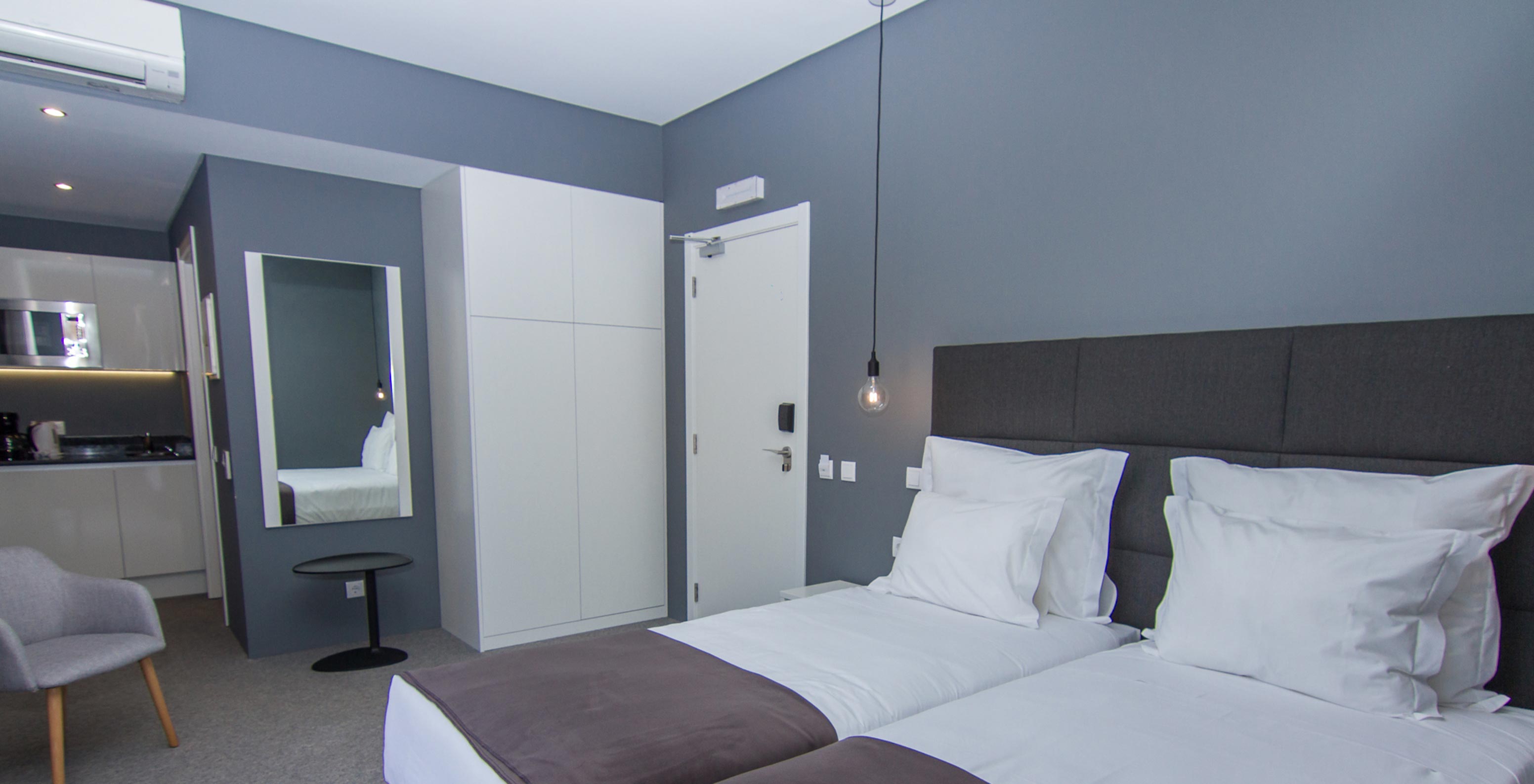 The Classic Room at Pestana Gramacho Residences is modern with 2 beds, kitchenette and seating area