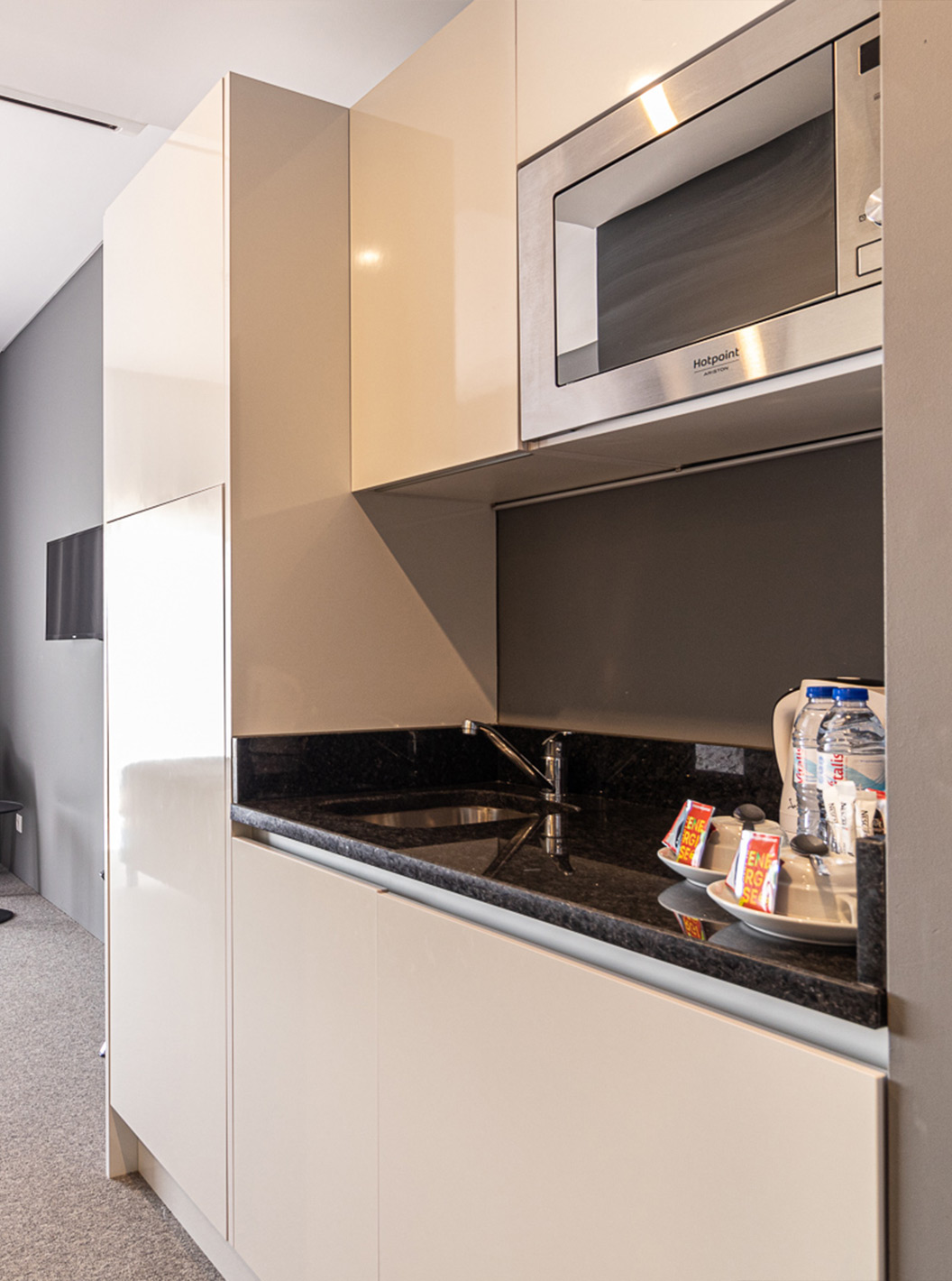Classic Room Pool View with bed, TV and compact kitchen at Pestana Gramacho Residences