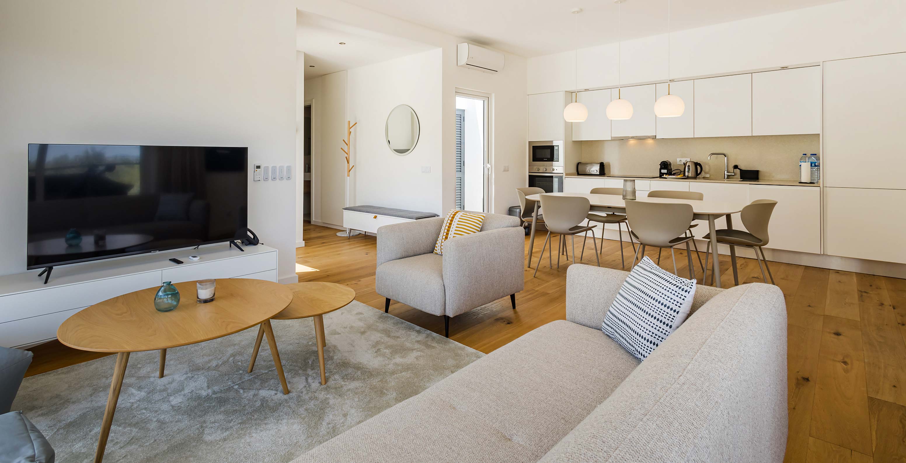 Pestana Valley Nature Village villa with a dining table, a sofa, and a television