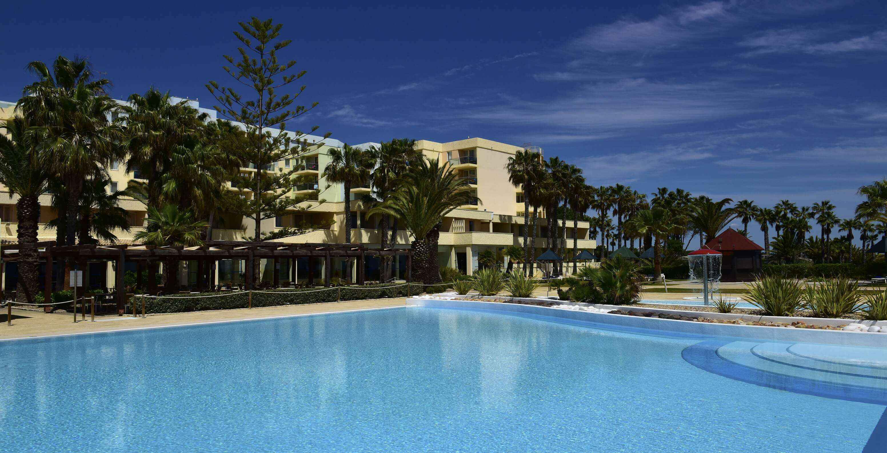 Pestana Viking outdoor pool on a sunny day, with a bar and a small children's pool