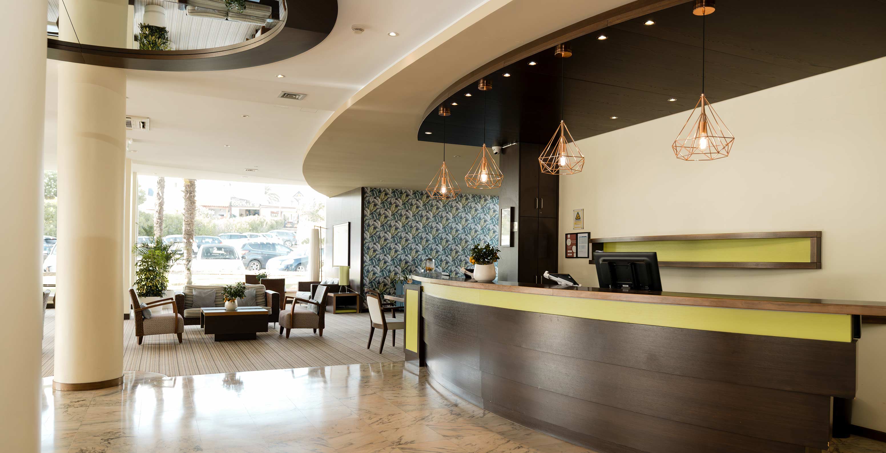Hotel reception with pool in Armação de Pêra, lounge with natural light and comfy chairs and sofas