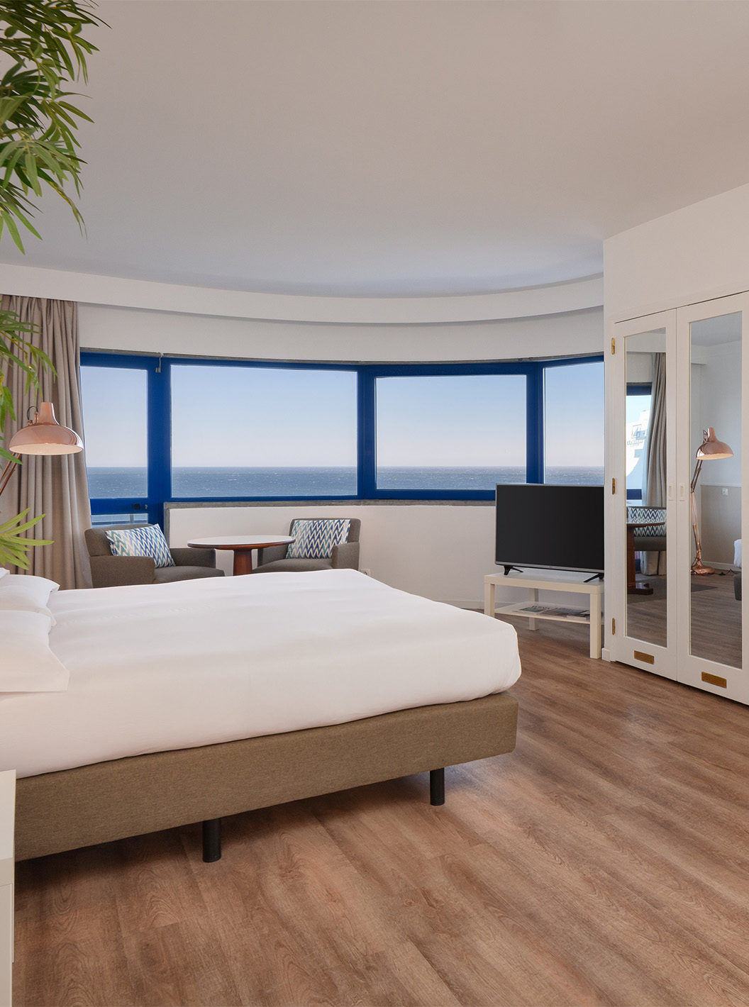 The Superior Deluxe Sea View room at Pestana Cascais has a double bed, a TV, a mirror, and a sea view