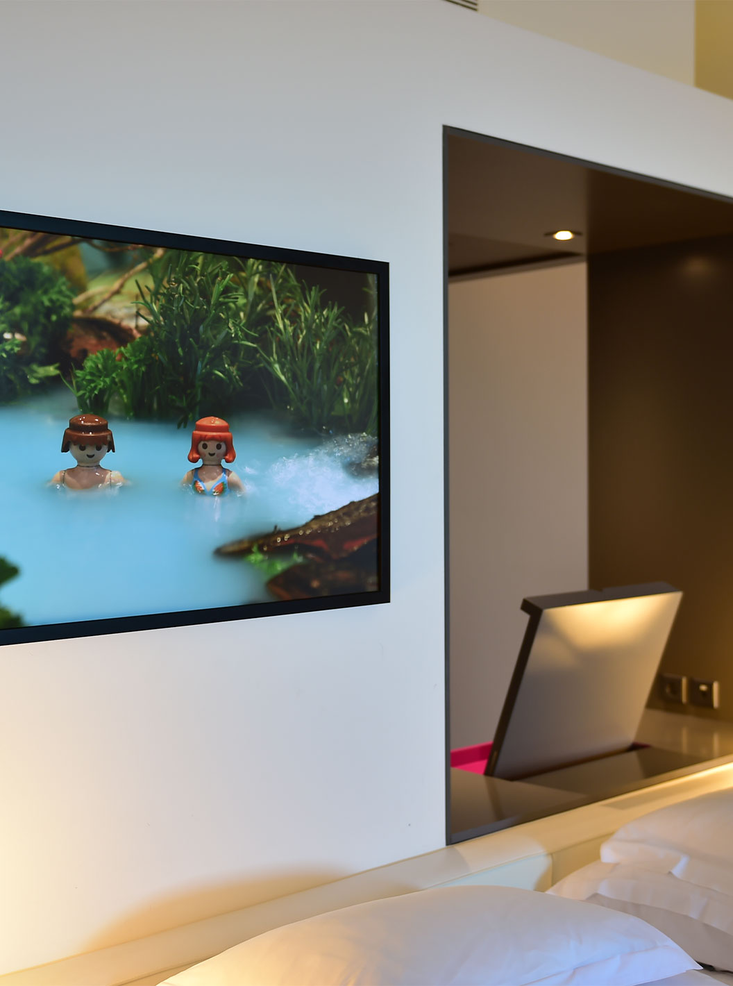 The Junior Suite Art District at Pestana Cidadela Cascais features a colorful painting with Playmobil elements on the wall