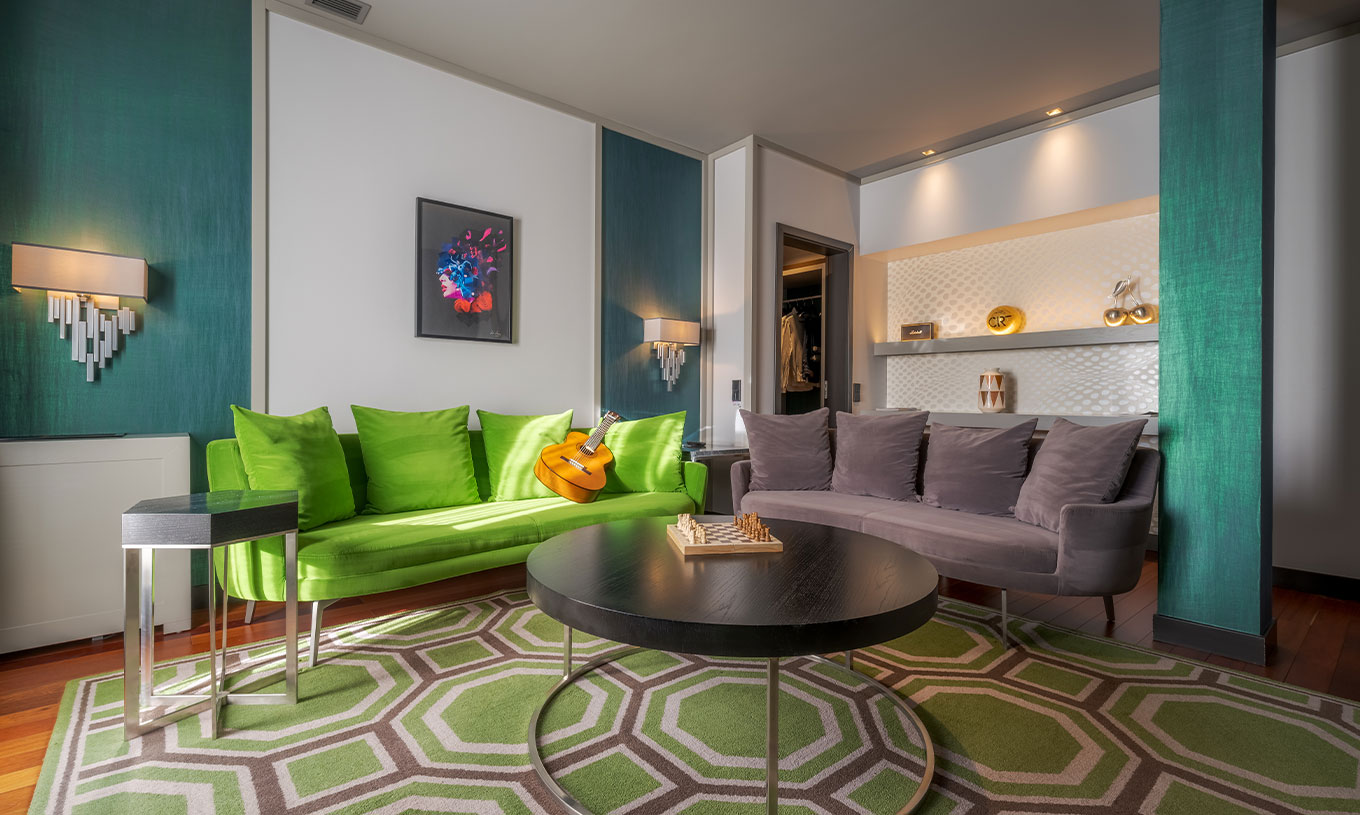 The CR7 Suite at Pestana CR7 Lisboa includes a sitting area with two sofas and a coffee table