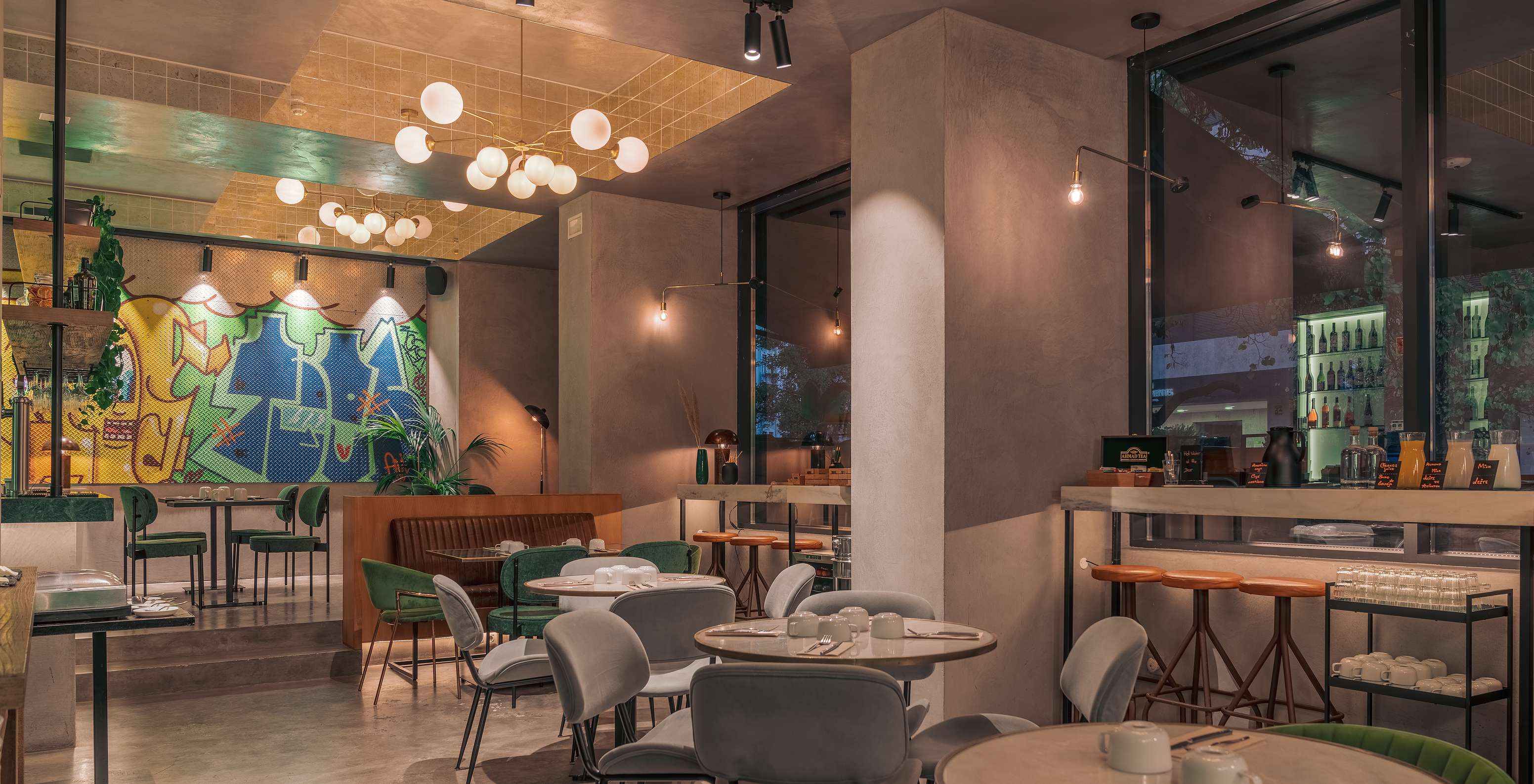 Restaurant at Pestana Lisboa Vintage with colorful tables and chairs, hanging lamps and tall counters with chairs