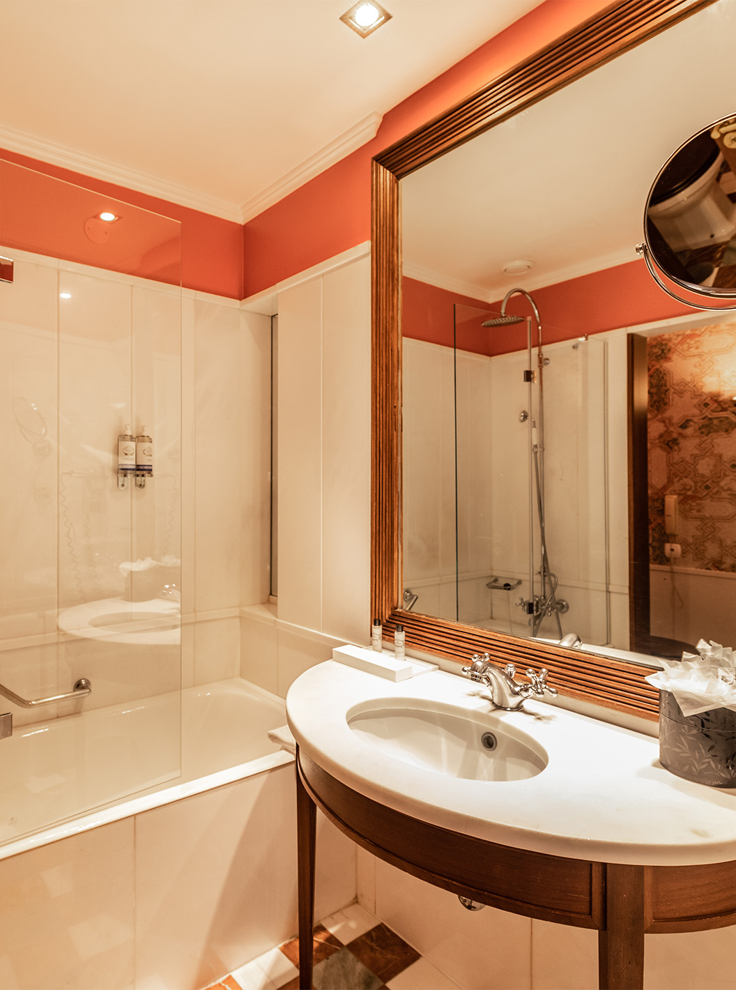The Premium Balcony room at Pestana Palace Lisbon features a bathroom with a bathtub and sink with a mirror