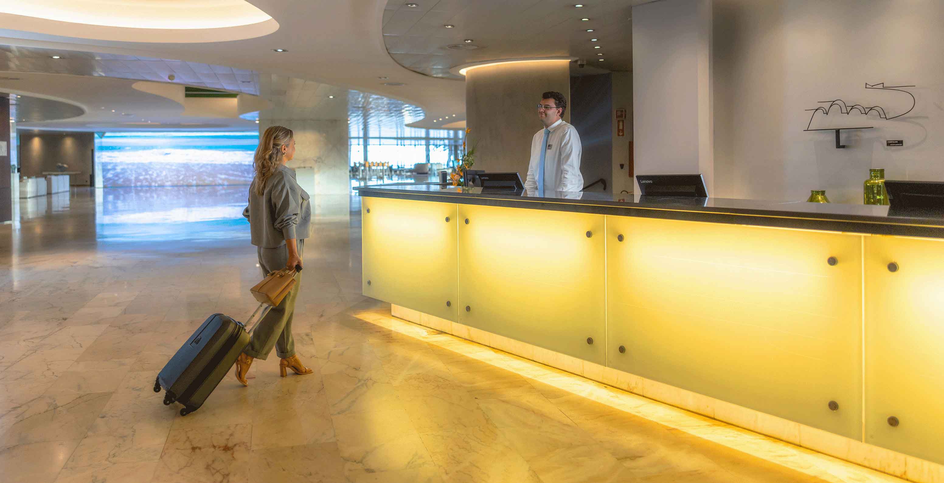 Reception with smiling staff member at Pestana Casino Park, hotel in Funchal by the sea, with spa and pool