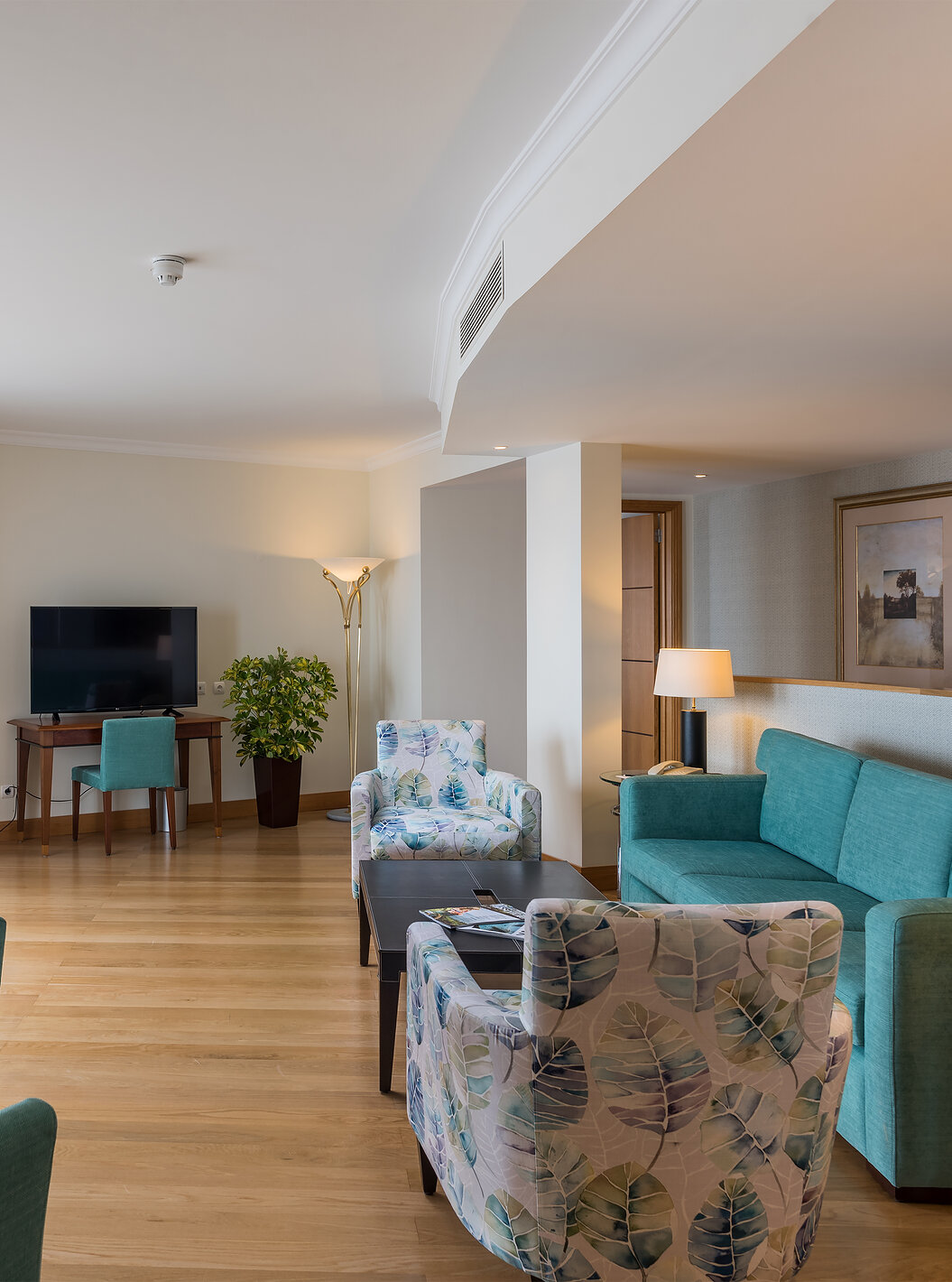 The Master Suite Sea View at Pestana Grand has a living room, sofa with chairs and coffee table, and TV