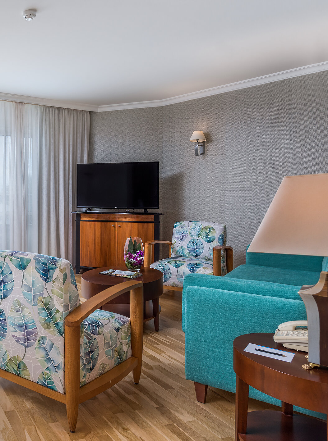 The Standard Suite Sea View at Pestana Grand has a living room, with small dining table and TV