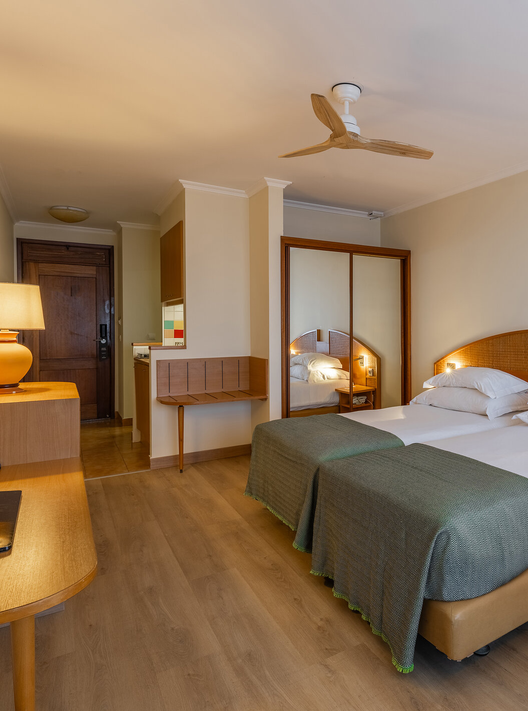 The Pestana Ocean Bay All Inclusive Classic Sea View has two single beds joined together, a wardrobe with a mirror and a TV