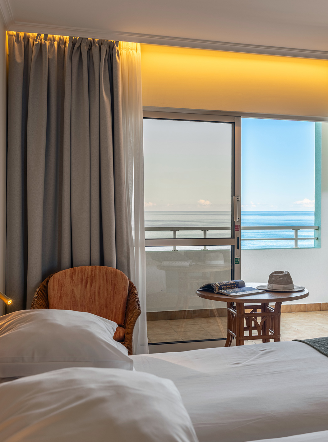 The Pestana Ocean Bay All Inclusive Classic Sea View has a double bed, two chairs, and a balcony with sea view
