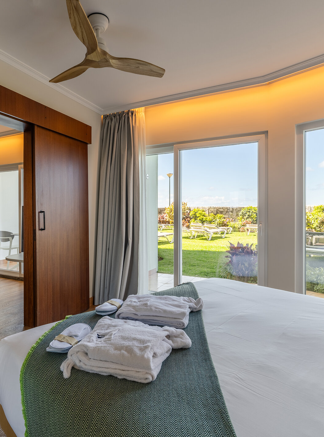 The Pestana Ocean Bay All Inclusive Junior Suite Sea View has a double bed with a garden view and a living room
