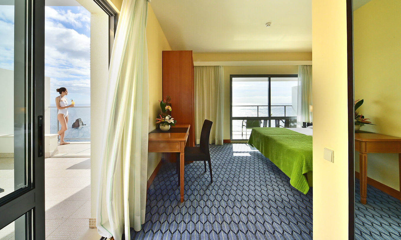The Suite Sea View of Pestana Promenade has a desk with a chair and a spacious balcony where you can have a cocktail