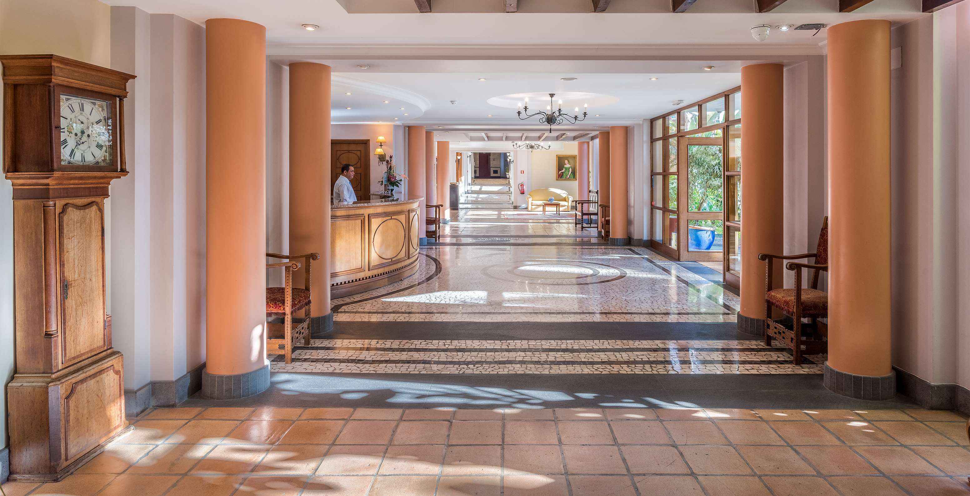 Reception corridor at Pestana Miramar, a hotel in Madeira near the beach, with brick floor resembling cobblestones