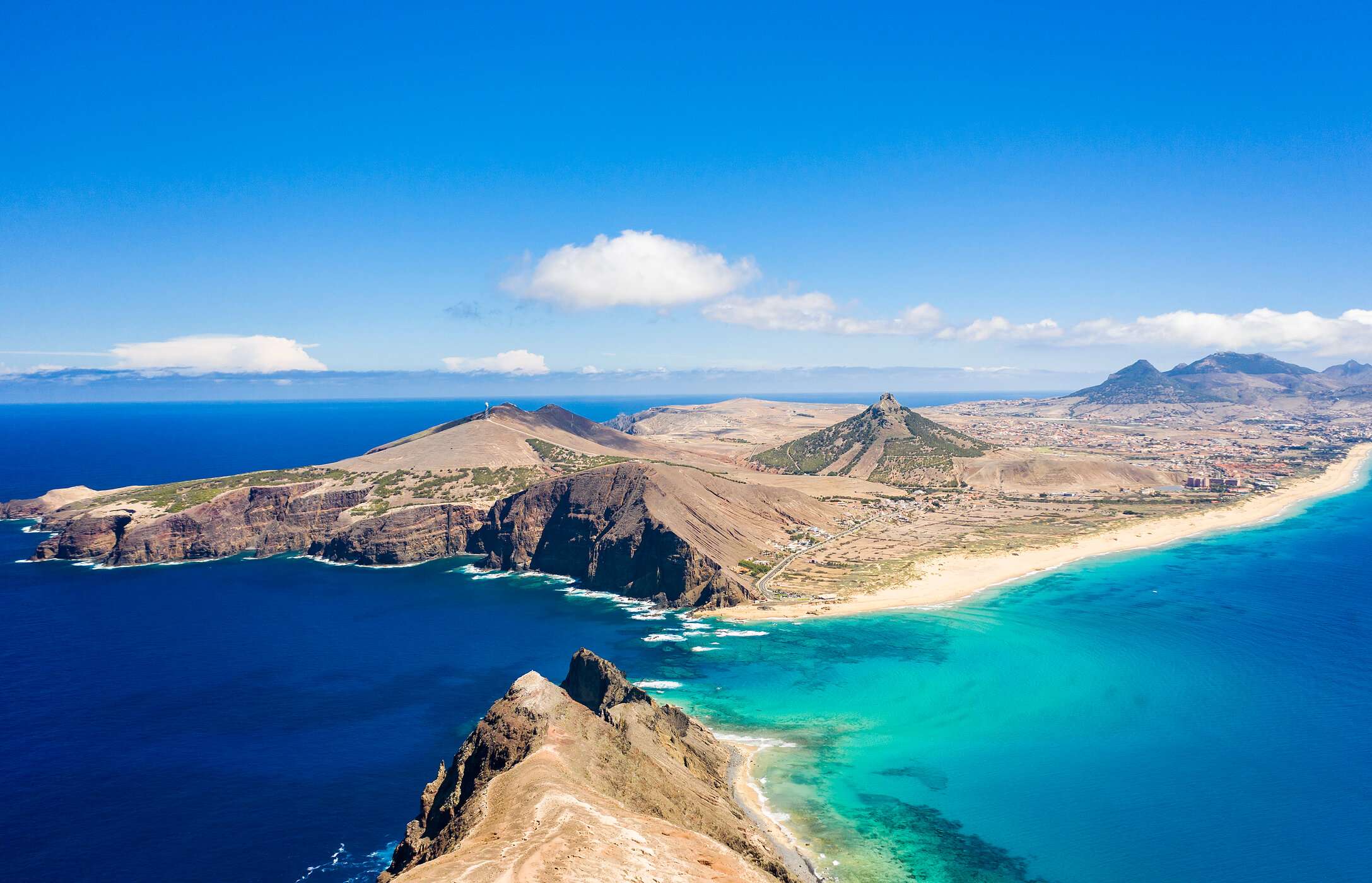 Panoramic view of Porto Santo, showing its golden beaches and stunning coast, with blue sea