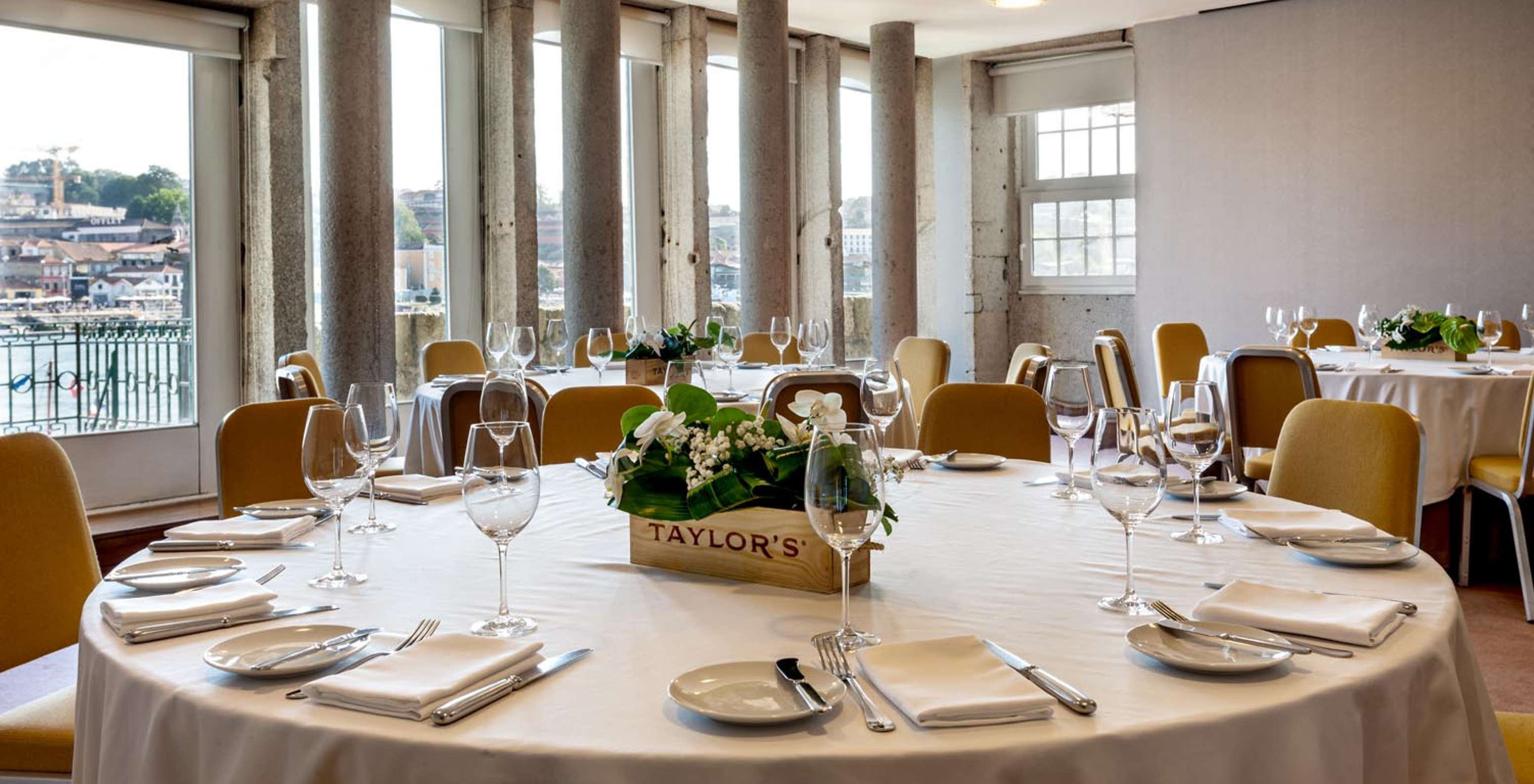 Round tables at a restaurant overlooking the Douro at Pestana Vintage Porto, a hotel at Praça da Ribeira