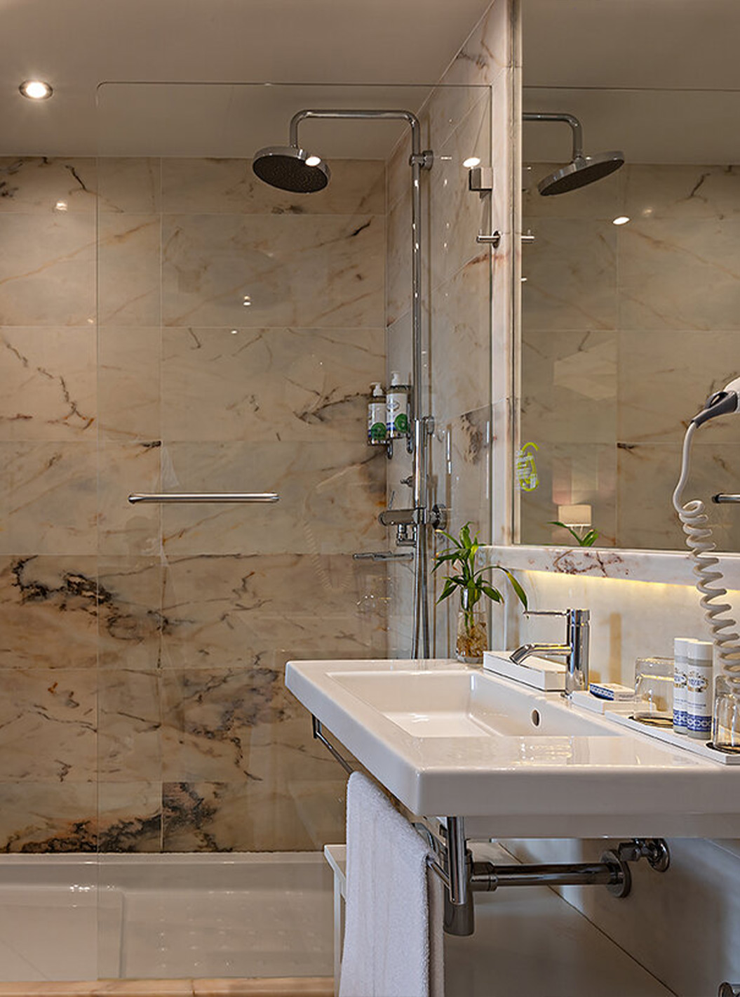 The Classic at Pestana Vintage Porto has a bathroom with a sink and a shower surrounded by marble walls