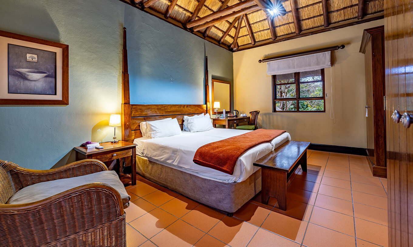 The Classic Room at Pestana Kruger Lodge has two single beds, one chair and has wooden decor