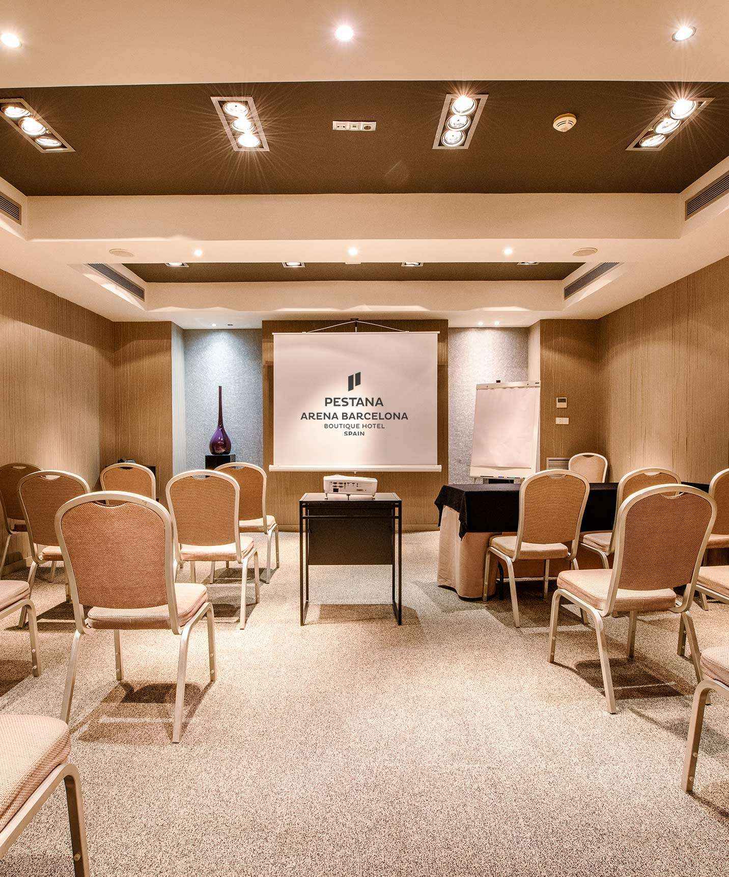 Hotel in Barcelona has a meeting and conference room with a table and several chairs for seating many people
