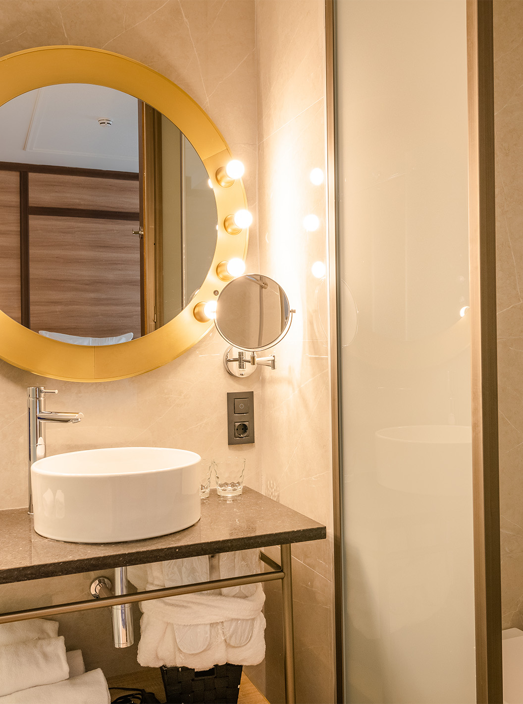 The Superior Room at Pestana CR7 Gran Vía Madrid includes a bathroom with a round mirror and sliding shower doors