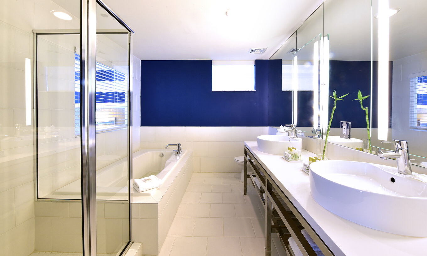 The Suite King with Balcony at Pestana Miami South Beach has a sink, large mirror, and shower or bathtub