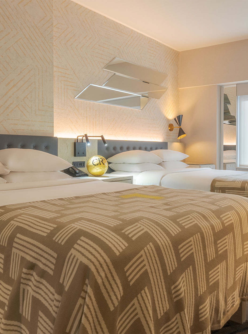 The Superior Double at Pestana CR7 Times Square has two beds with a bedspread with the number seven and a window