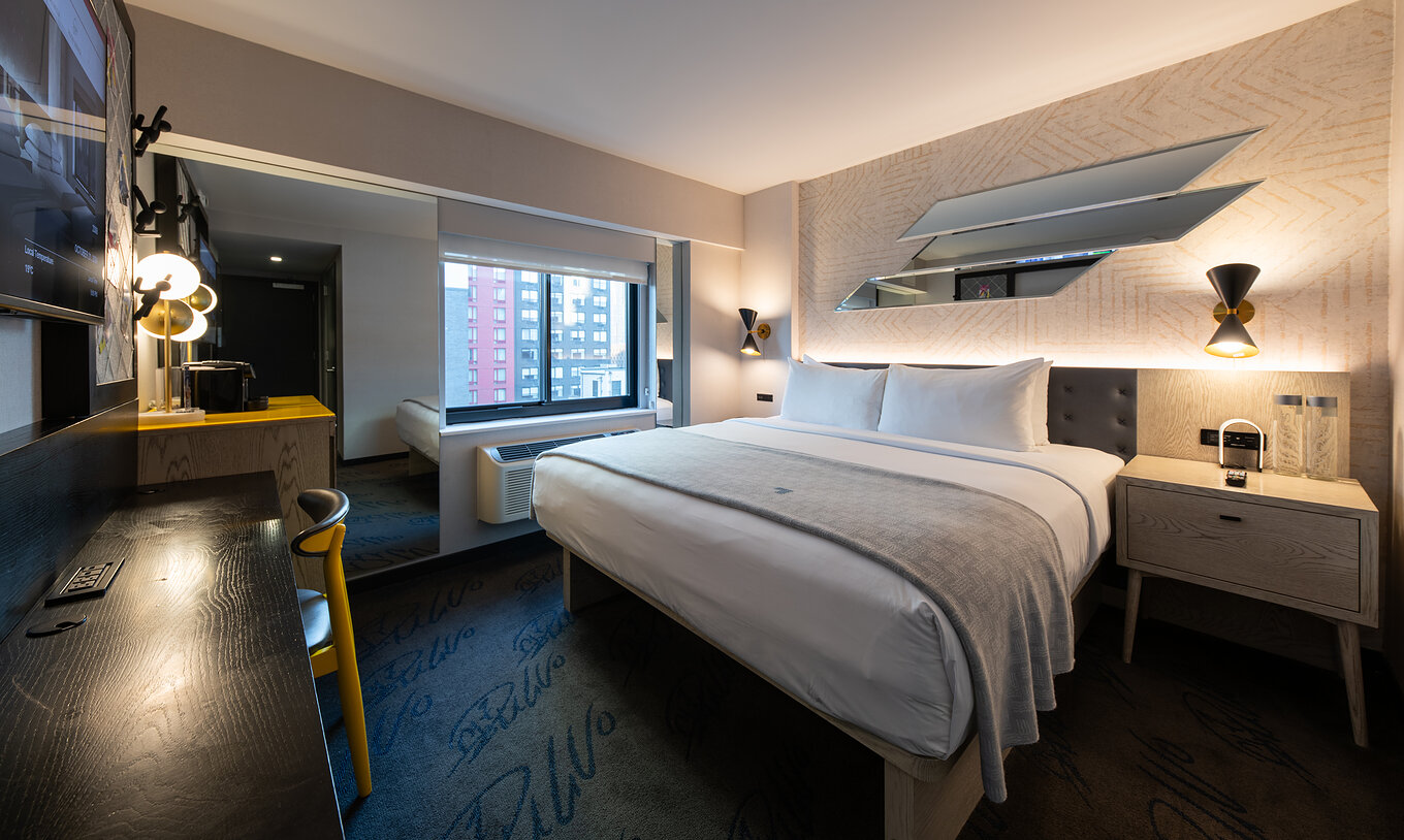 The Superior King High Floor at Pestana CR7 Times Square has a double bed, desk, and TV