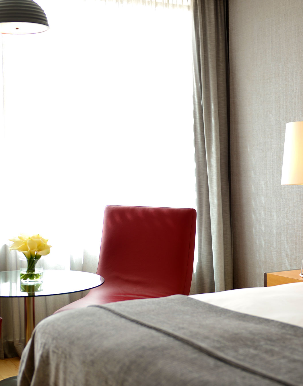 La Habitación Superior con Balcón del Pestana Cidadela Cascais tiene una cama doble y una pequeña mesa con una silla roja