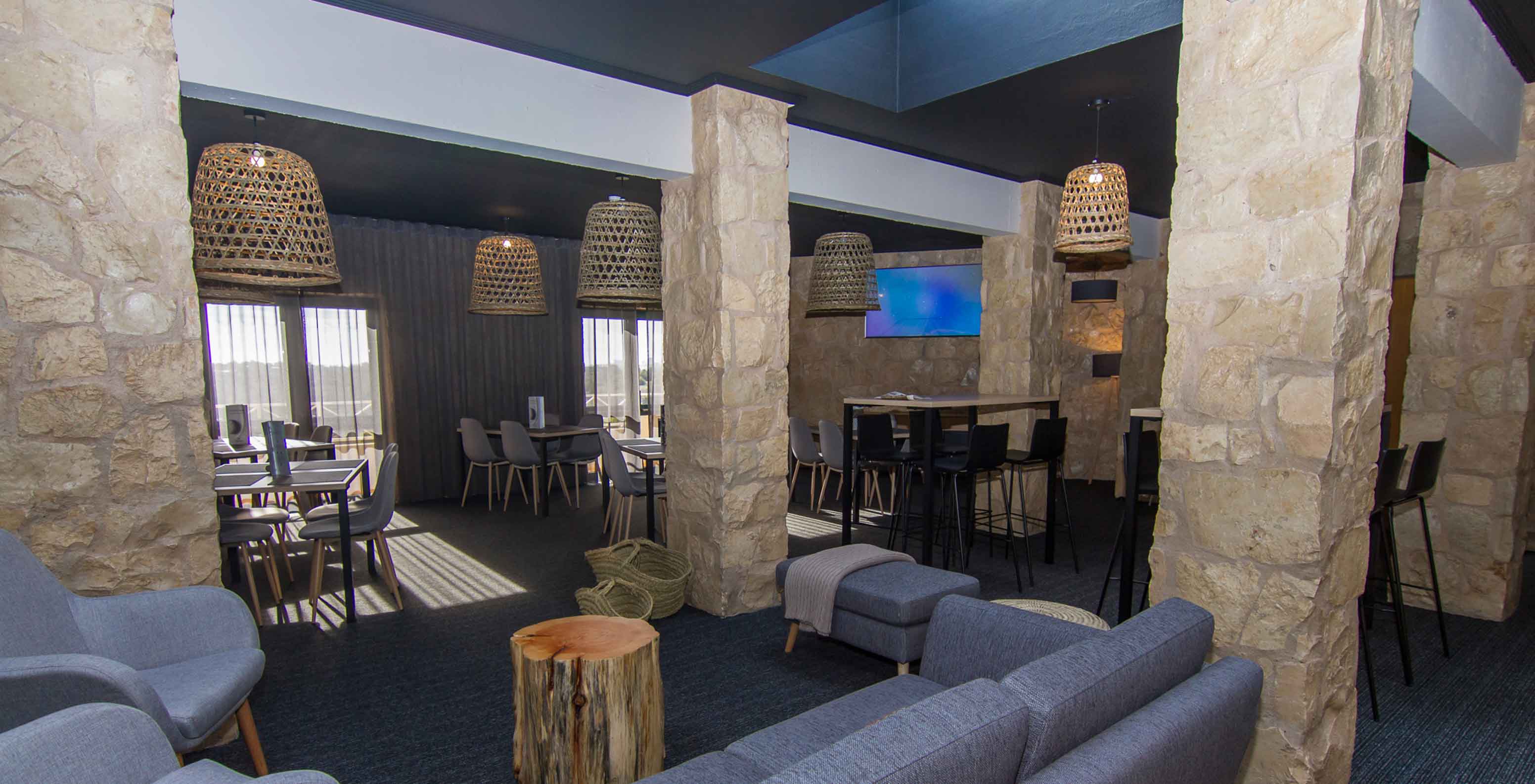  Het Restaurant Fairway, van het 4-sterren familiehotel in Algarve, heeft een ruimte met lampen, tafels en stoelen